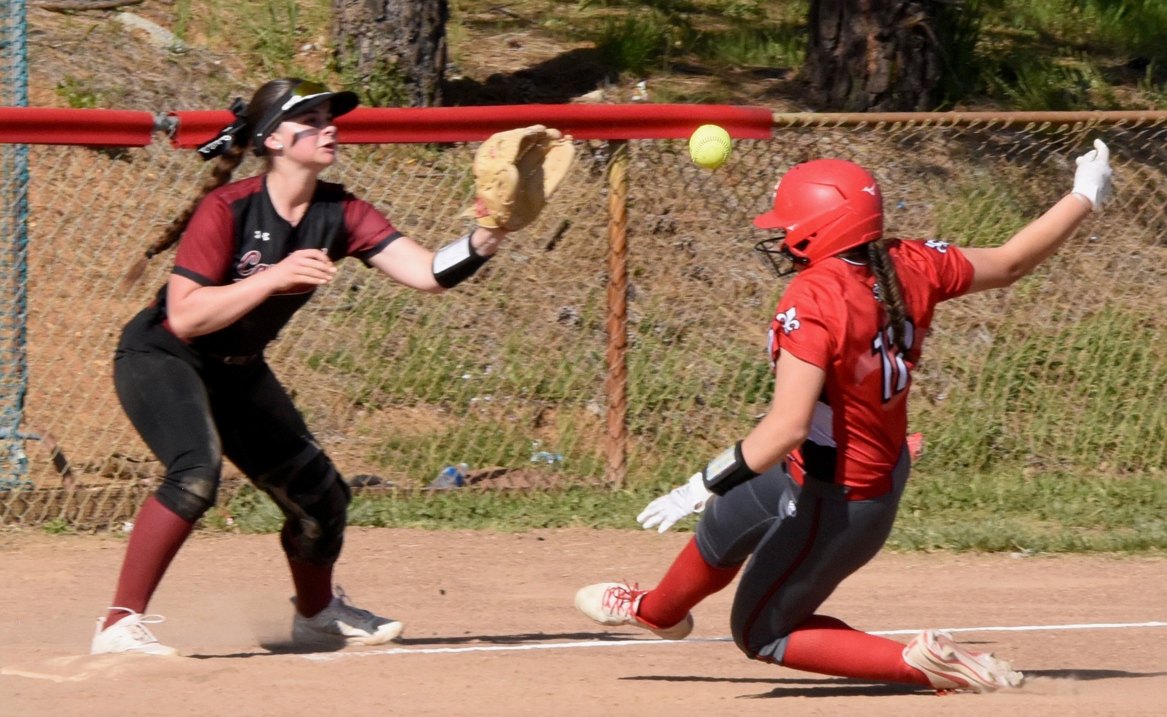 Clear Lake third baseman Camrin Pivniska takes the throw at third base from teammate Amber Smart to force a St. Helena runner Friday afternoon during the Cardinals' 13-2 loss to the visiting Saints. Pivniska had one of only two Clear Lake hits against St. Helena ace Aribella Farrell. (Photos courtesy of Trett Bishop)