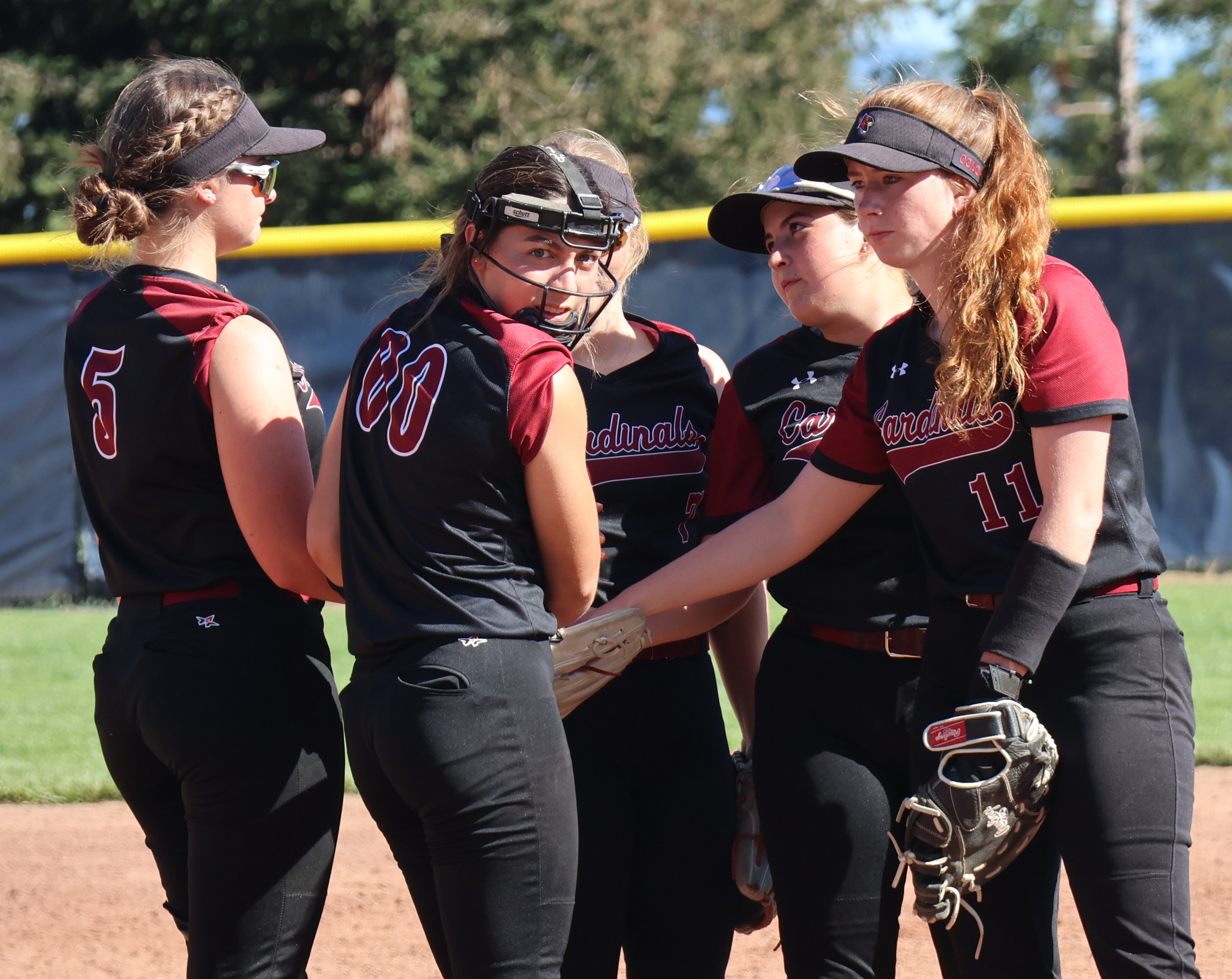 From left, Camrin Pivniska, Atiana Patino, Amber Smart, Grace Gomez and Stella Hill huddle before the start of the third inning Wednesday afternoon at Mendocino College in Ukiah. Patino worked three scoreless and hitless innings to pick up the victory in a 2-0 non-league win over Fortuna. (Photos by Brian Sumpter)