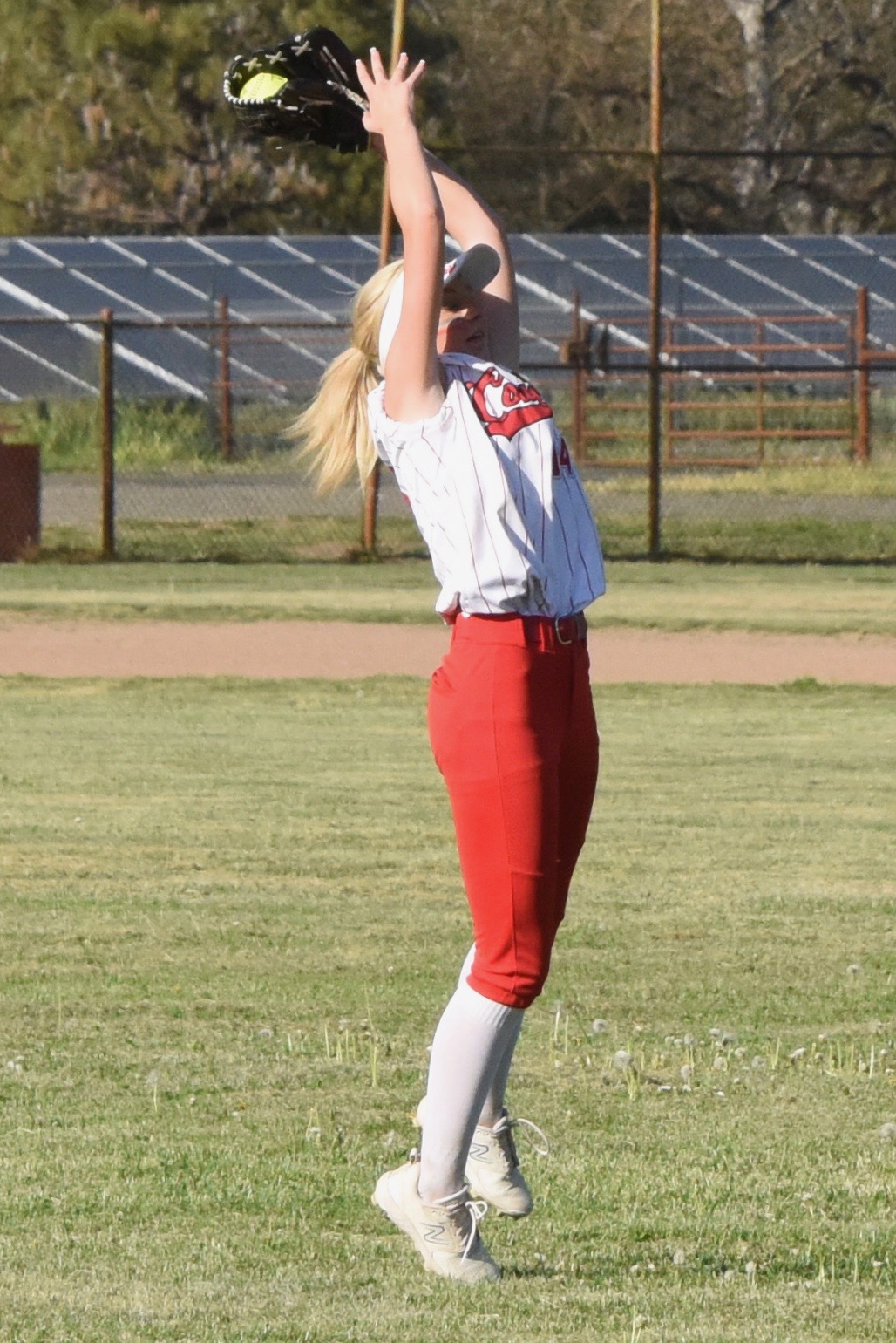 Upper Lake's Ashlyn Rhodes snares a line drive in left field to end the top of the eighth inning with Credo runners at second and third. (Photos courtesy of Trett Bishop)