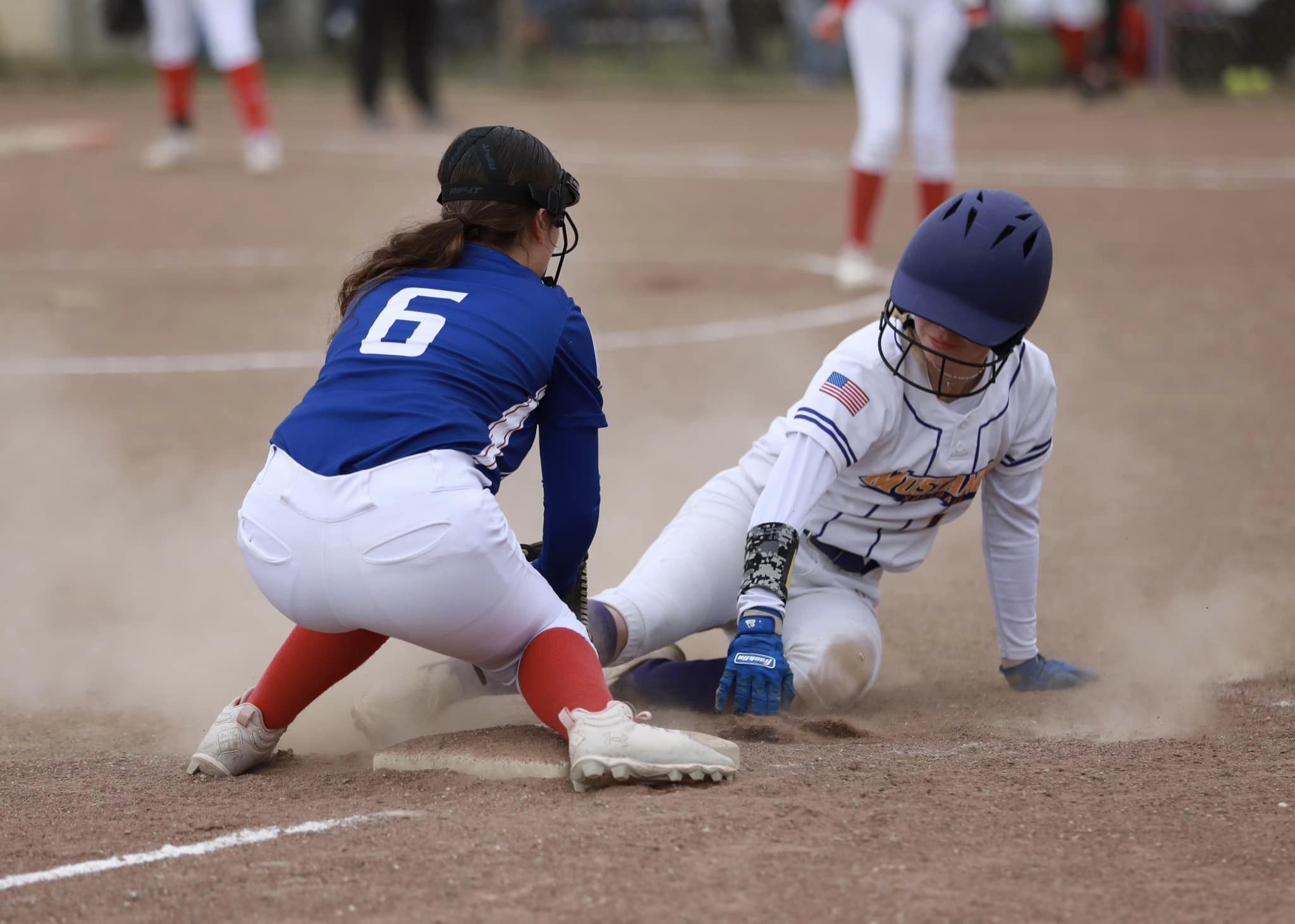 Middletown's Carina Fleenor scrambles back to third base as Lower Lake's Marriah Perez slaps down a tag. (Photos courtesy of Megan Buckley Cutting)