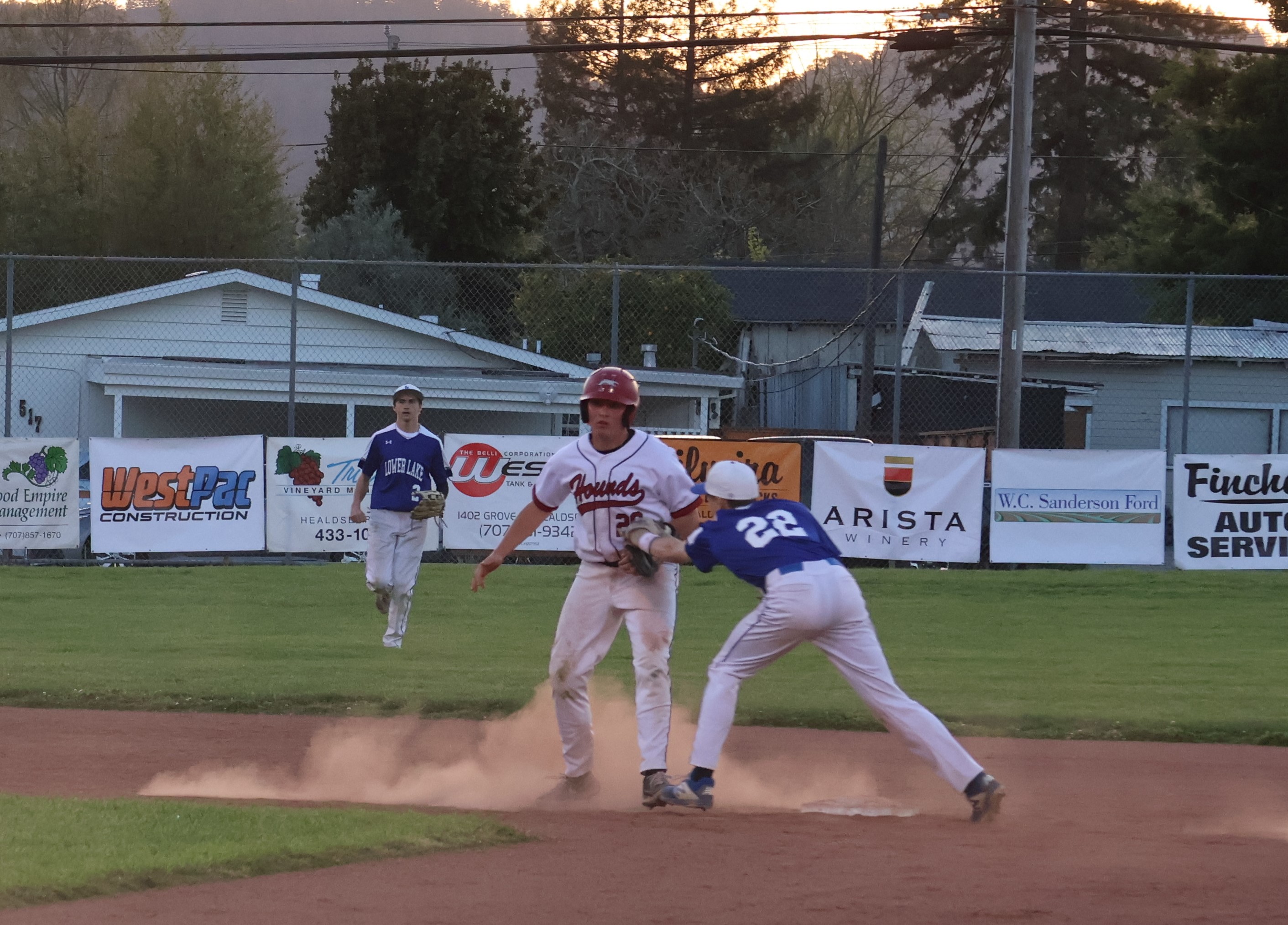 Lower Lake shortstop Jett Guralas tags out a Healdsburg runner at second base in the bottom of the second inning as left fielder Dylan Sherman looks on. (Photos by Brian Sumpter)