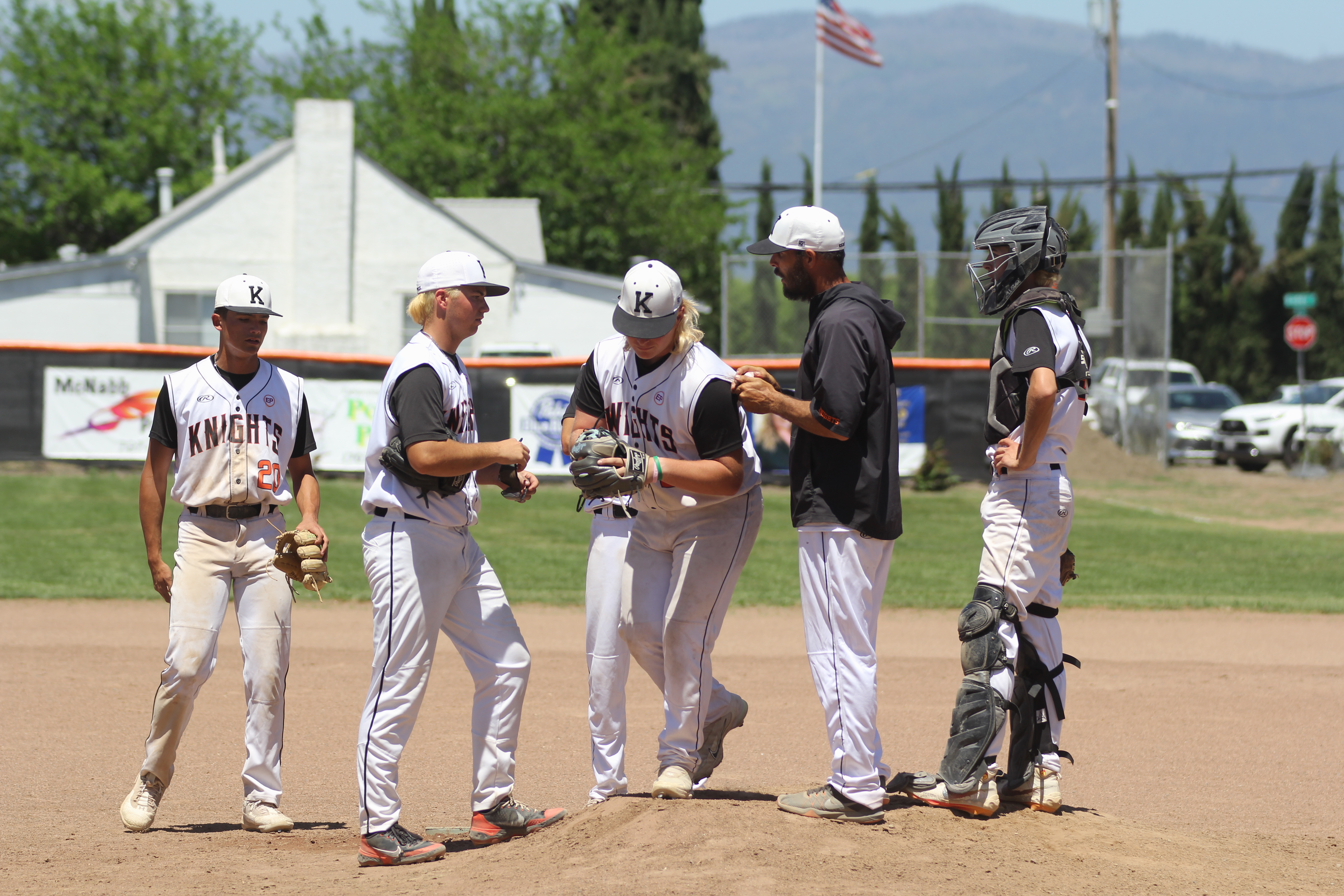 Kelseyville head coach Billy Shaul takes the ball from starting pitcher Jon Dougherty while making a pitching change in the top of the third inning. (Photos by Minenna Photography)