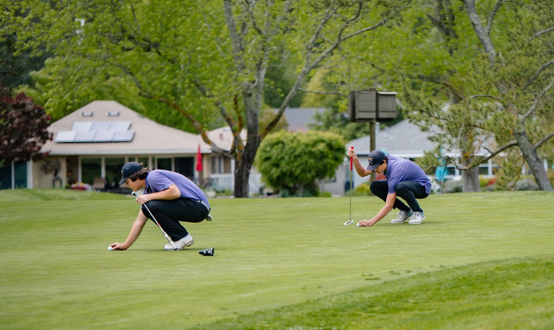 Middletown's Cooper Johnson (left) and Bodhi Moore line up putts. (Photos courtesy of Geri Costlow)