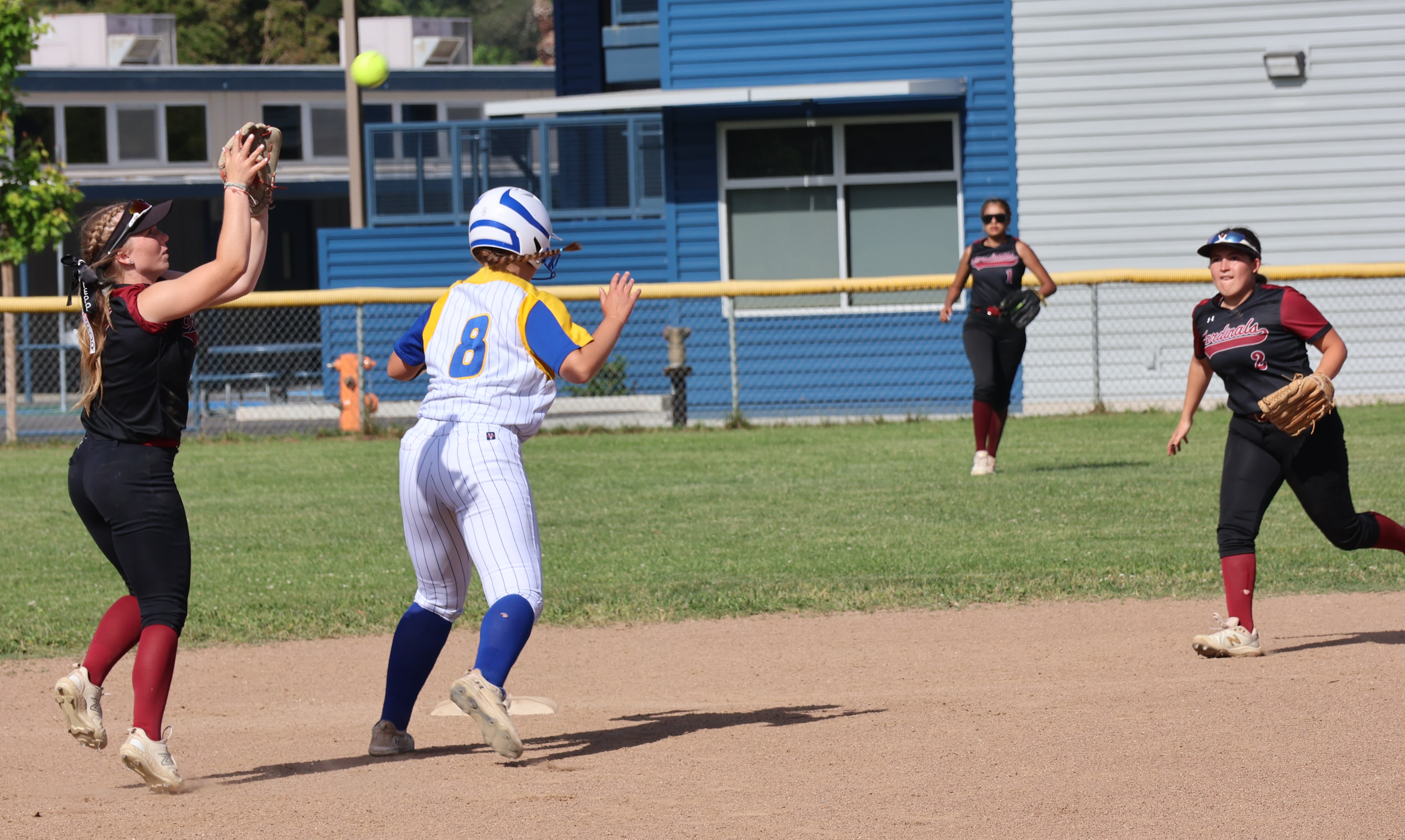 Clear Lake shortstop Amber Smart gloves a soft line drive in the bottom of the first inning as Cloverdale's Rylee Reasoner retreats to second base. Looking on is Clear Lake second baseman Grace Gomez and right fielder Rubi Ford. (Photos by Brian Sumpter)
