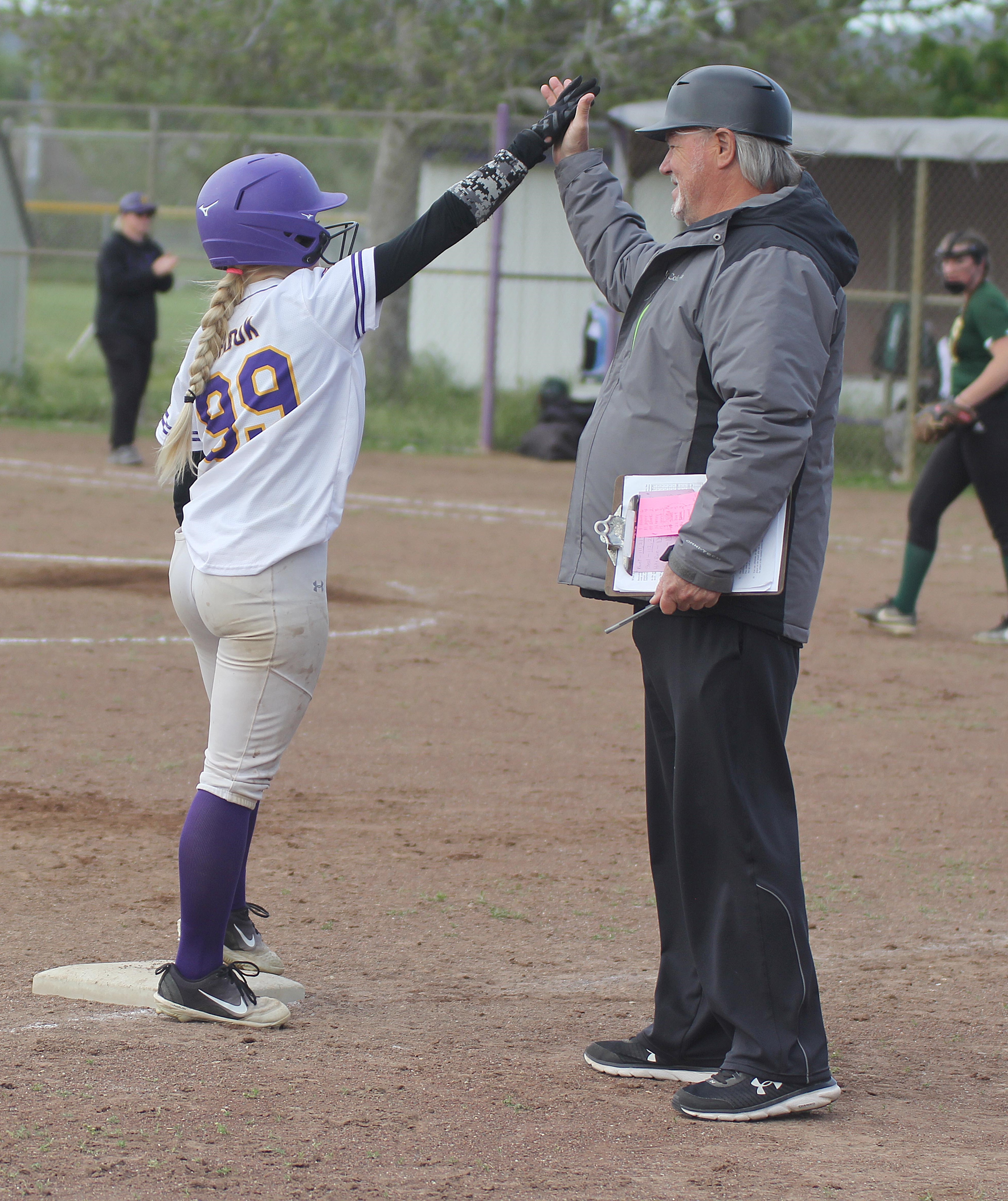 Middletown senior Pailey Shook exchanges high-fives with head coach Bob Gunion after hitting a triple. She tripled twice and drove in three runs in a 17-7 league win over Willits. (Photos by Minenna Photography)