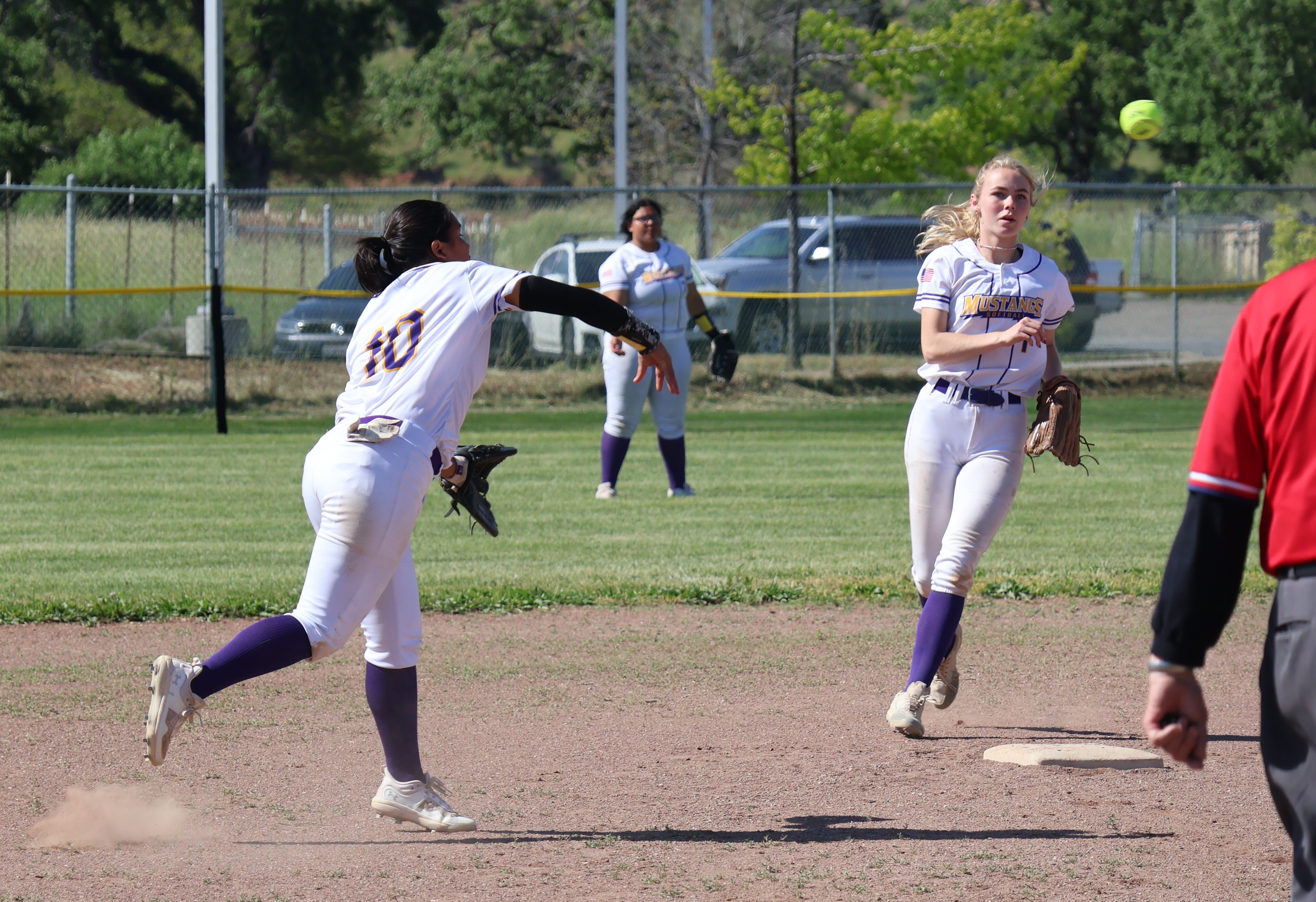 Middletown shortstop Breanna Pyzer, filling in for the injured Jaidyn Brown, throws out a runner at first base as second baseman Cora Holley looks on. (Photos by Brian Sumpter)