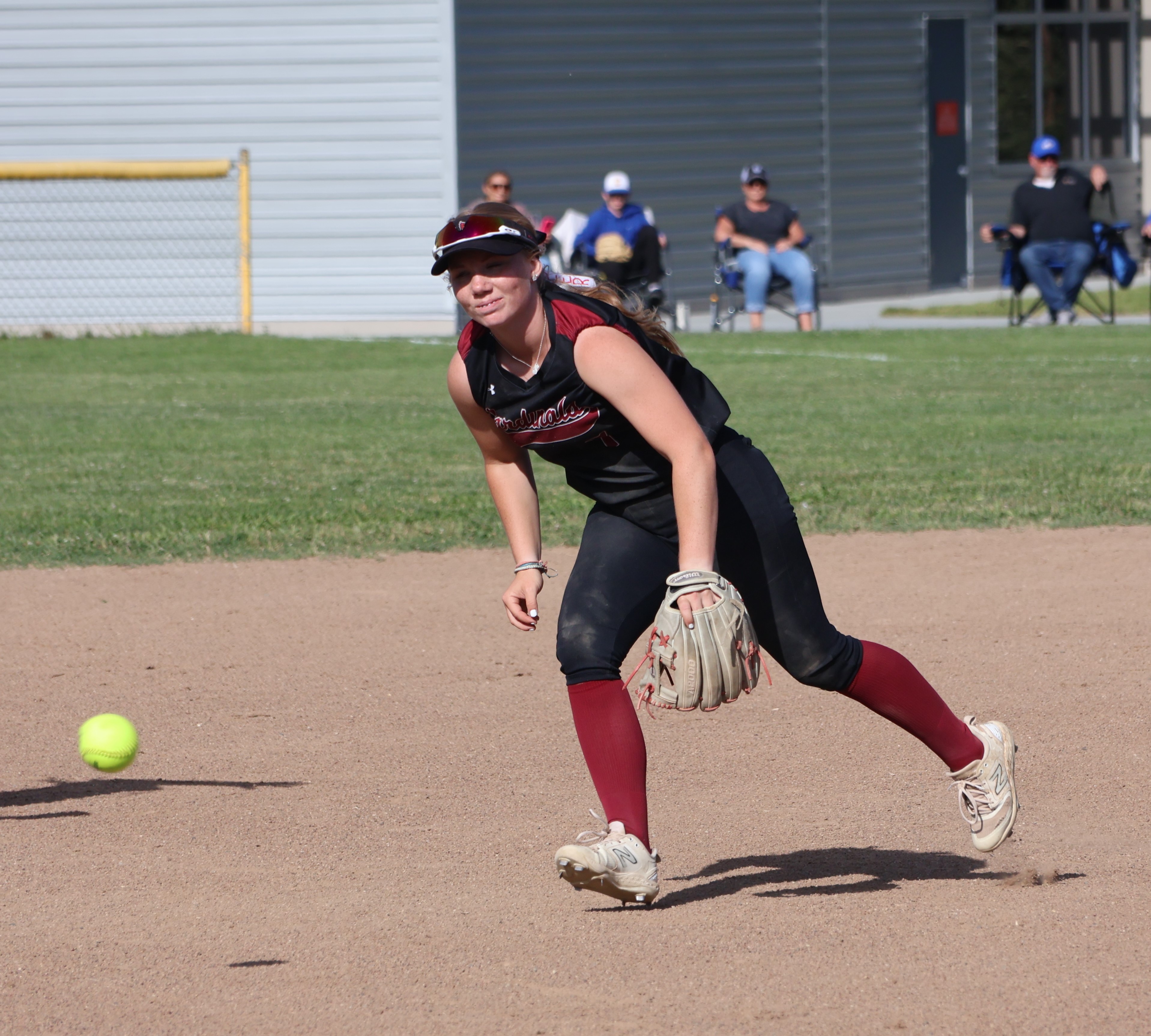 A Cloverdale player grounds a single into left field past shortstop Amber Smart in the bottom of the second inning. (Photos by Brian Sumpter)