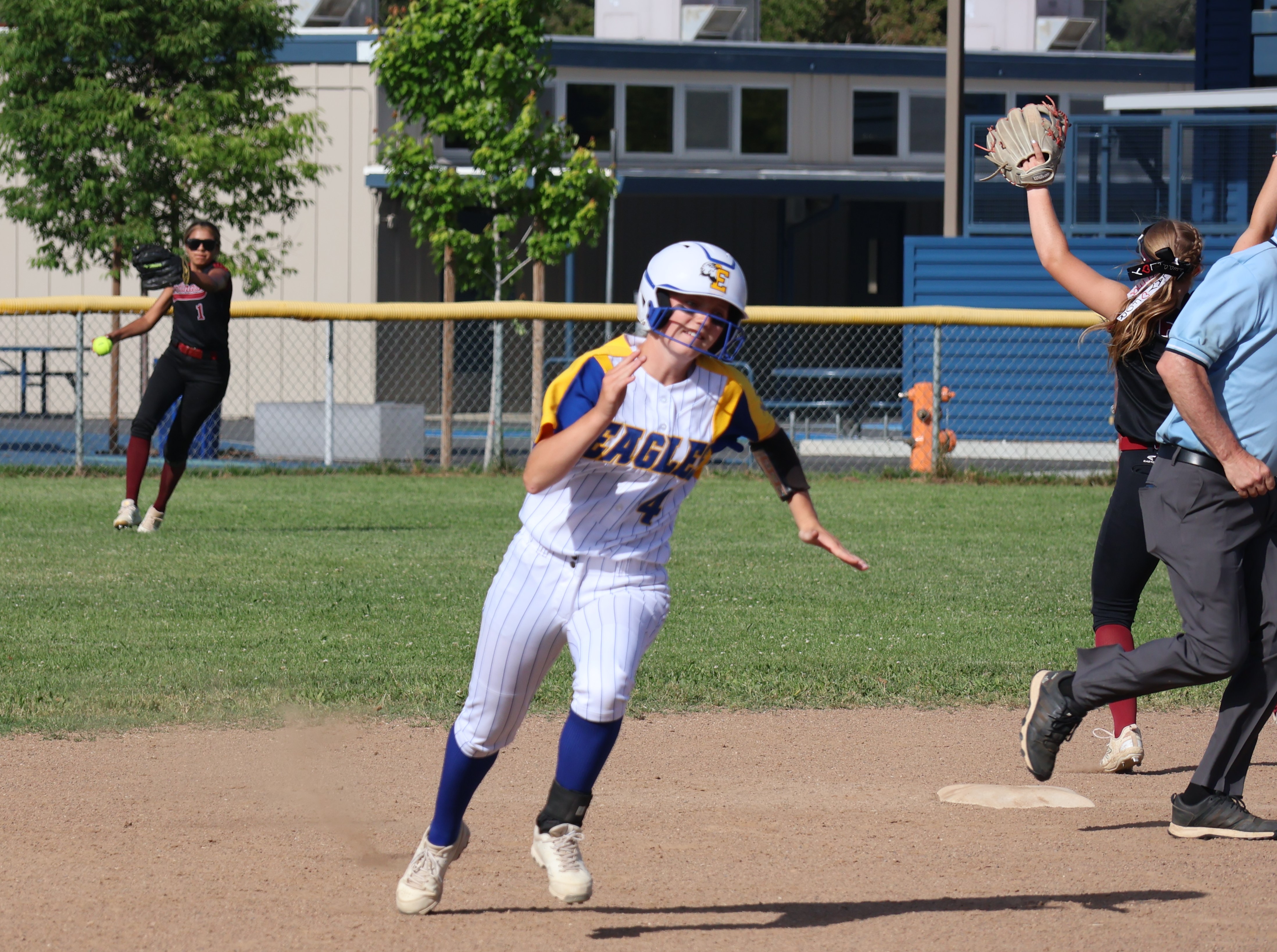 Cloverdale's Ginger Garrison rounds second base on her way to third on teammate Trinity Vlasak's RBI single into right field in the bottom of the second inning as Clear Lake's Rubi Ford returns the ball to the infield. (Photos by Brian Sumpter)