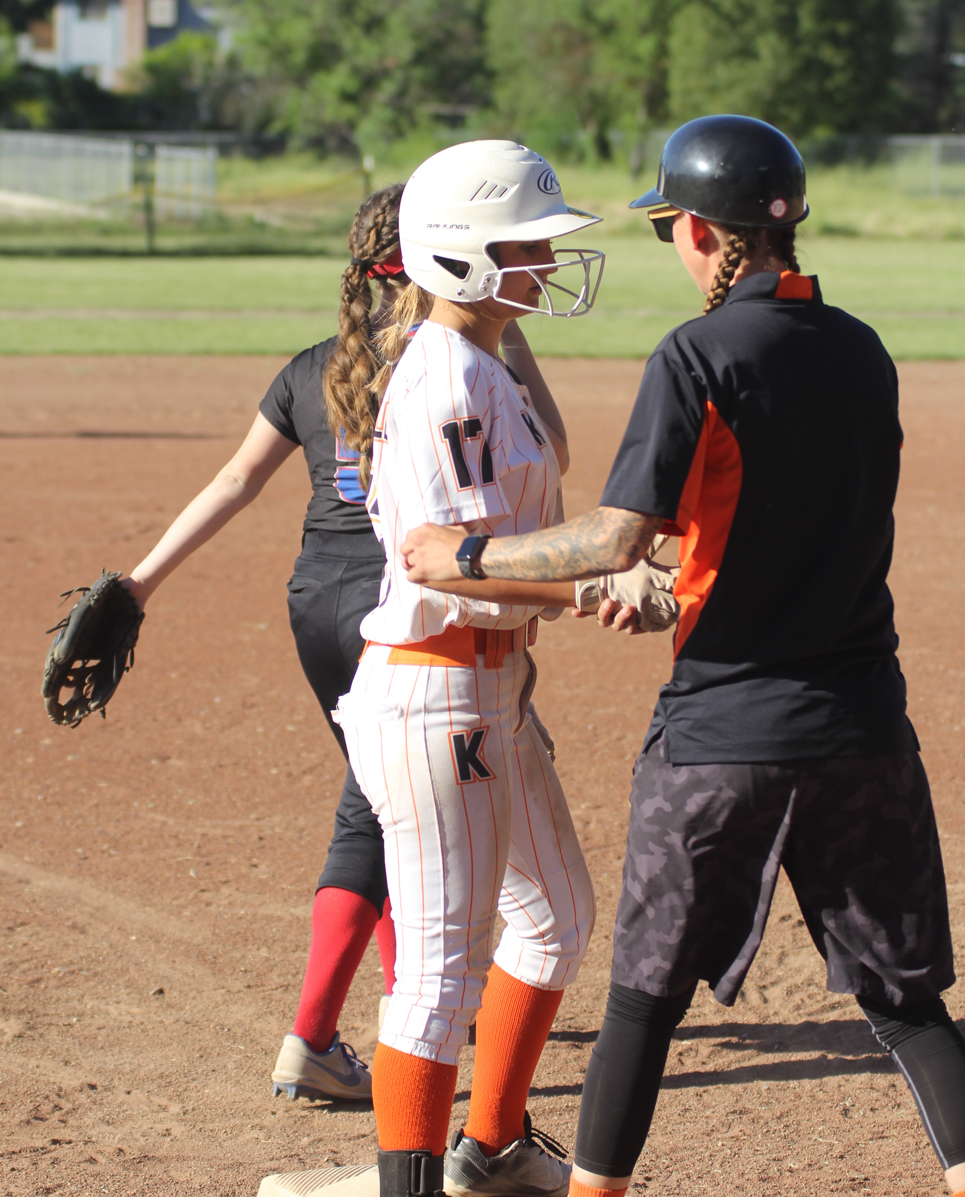Kelseyville head coach Julie Jackson greets Kat Wheelan at third base after Wheelan advanced on a wild pitch. She later scored the first run of the game for the Knights in a 6-4 playoff loss to Swett High School of Crockett on Tuesday afternoon in Kelseyville. (Photos by Minenna Photography)