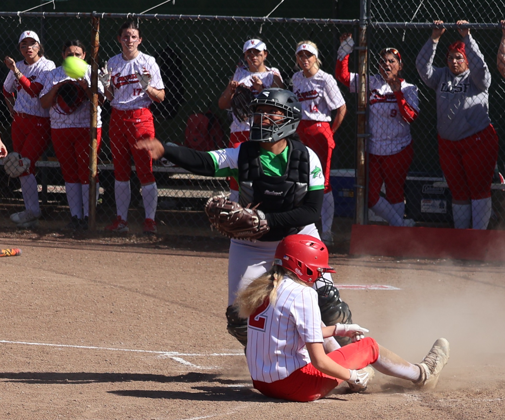 Upper Lake's Tristin Rhodes was out at the plate in the bottom of the second inning trying to score from first base on teammate Ashlyn Wurm's double. The Calistoga catcher throws down to third base in an attempt to nail Wurm, who advanced on the throw home. (Photos by Brian Sumpter)