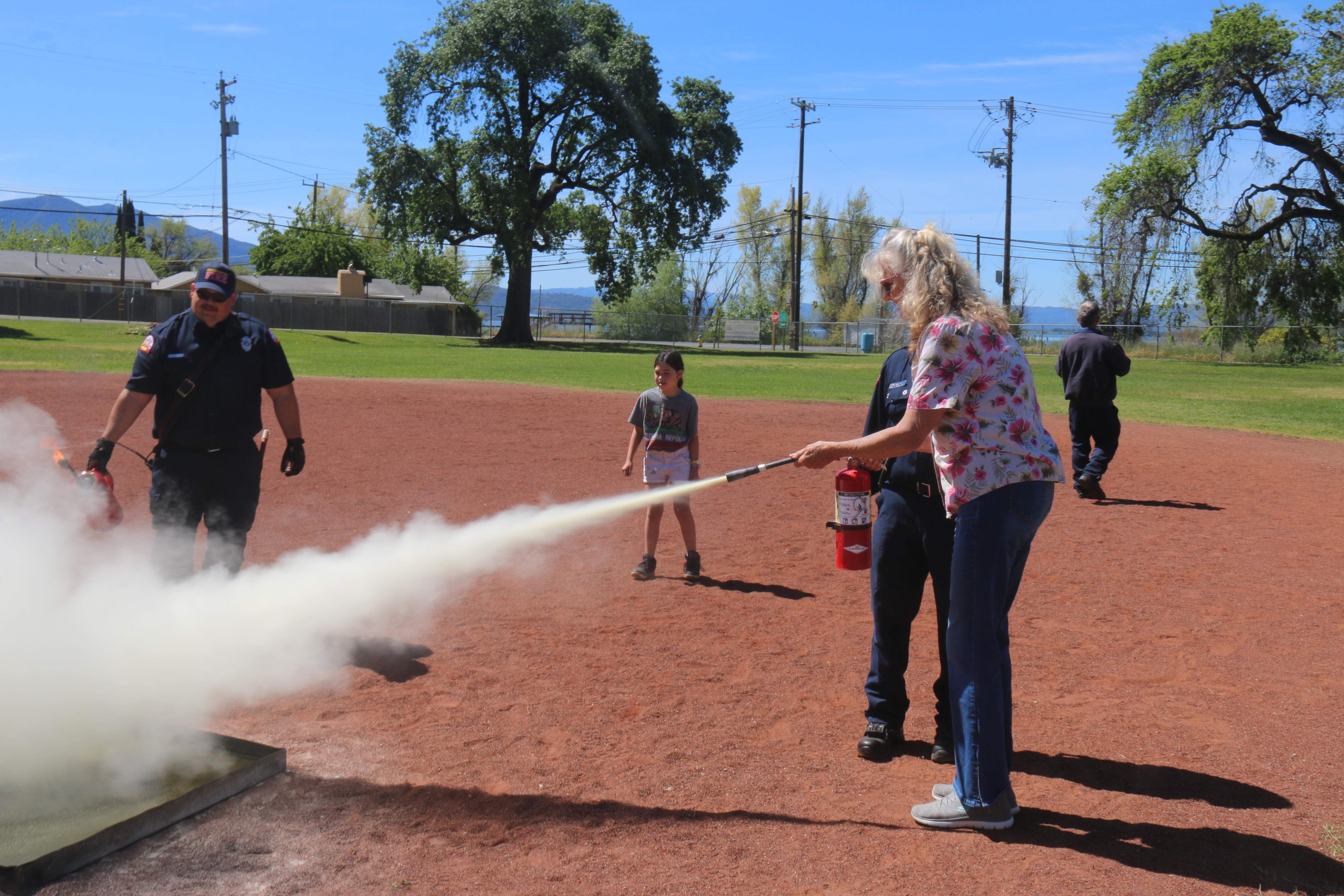 Barbara Higman, attendee at Ready Fest gets instruction to properly use an extinguisher from John Rodriguez, N. Shore Fire. William Roller- LAKE COUNTY PUBLISHING.engineer, at Lucerne Middle School, Apr. 27, 2024. William Roller Lake County Publishing