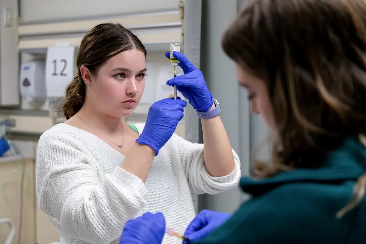 Nursing students Ashley Jensen, left, and Courtney Houtz practice injection procedures in the clinical skills lab at University of San Francisco in San Francisco, Calif. on Oct. 9, 2023. Health care is one of the areas that has added jobs since 2022. Photo by Amir Aziz for CalMatters