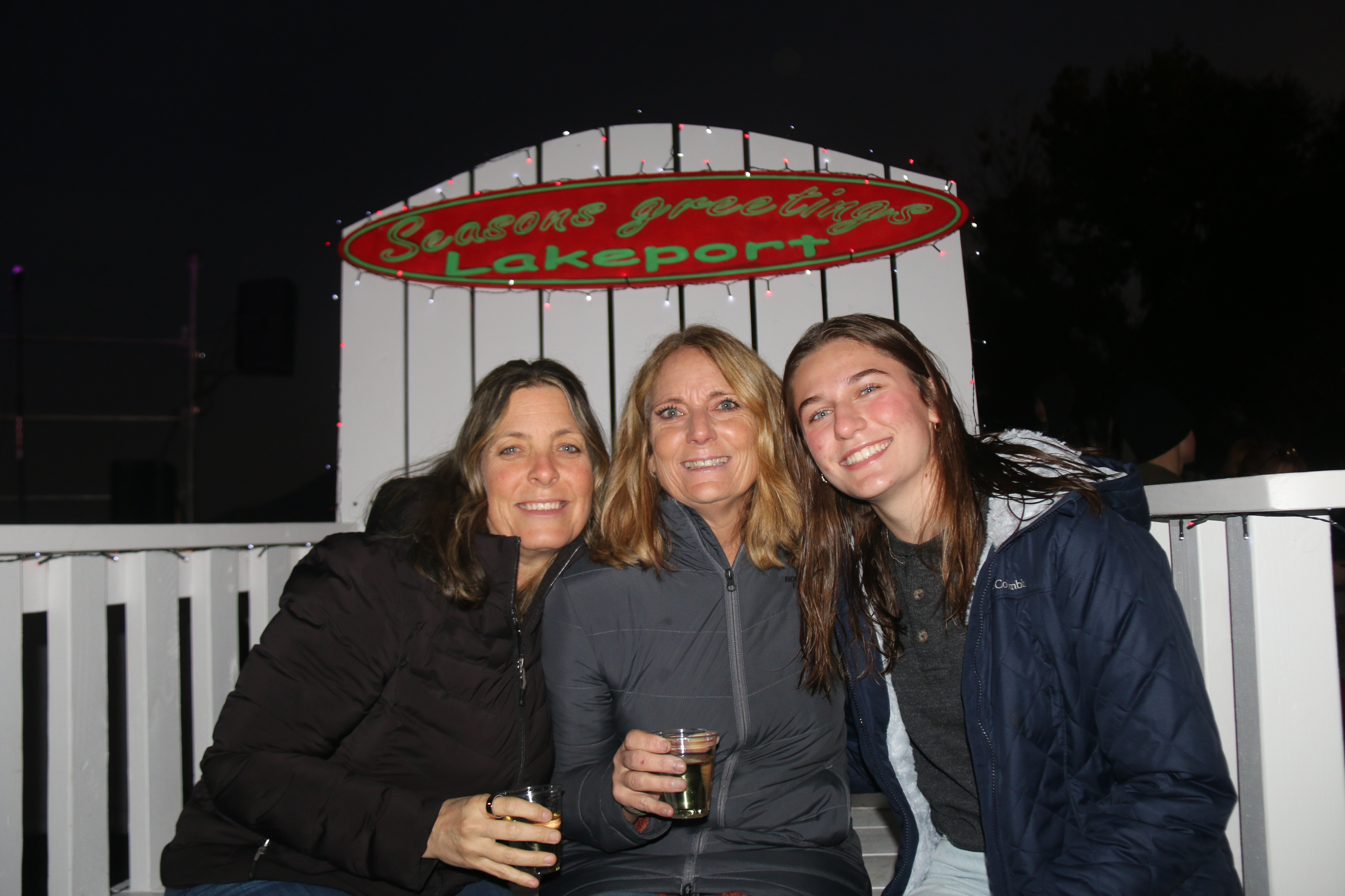 From left, Kristen Soderquist, Marti Psalmonds and Mati Mteer,relaxing on the Seasons Greetings throne anticipating the start of the first annual boat parade, on Clear Lake, Xabatin Park, Lakeport, Nov. 30, 2024. William Roller, Lake County Publishing.