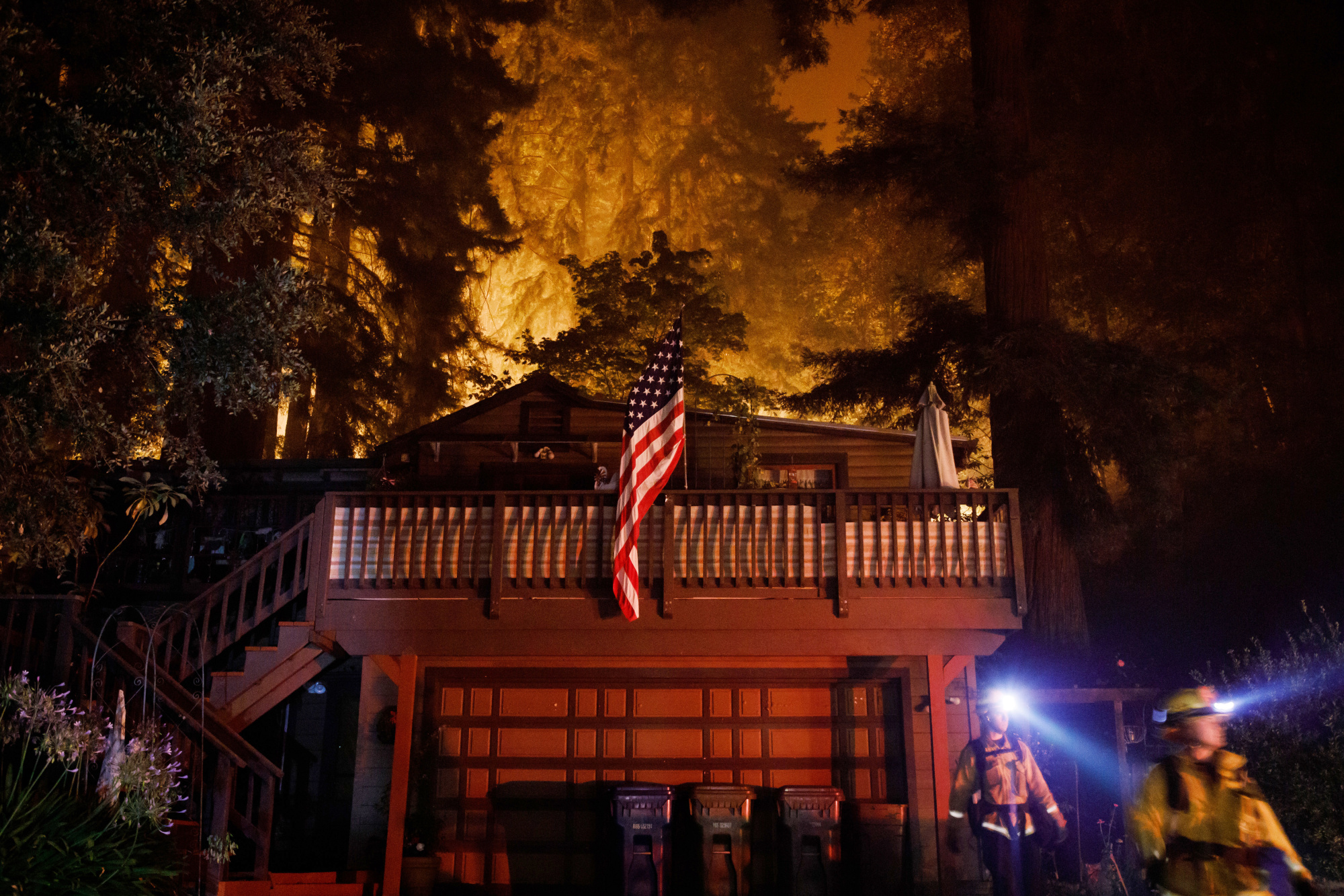 Firefighters work to protect homes from the CZU August Lightning Complex fire in Boulder Creek on Aug. 21, 2020.