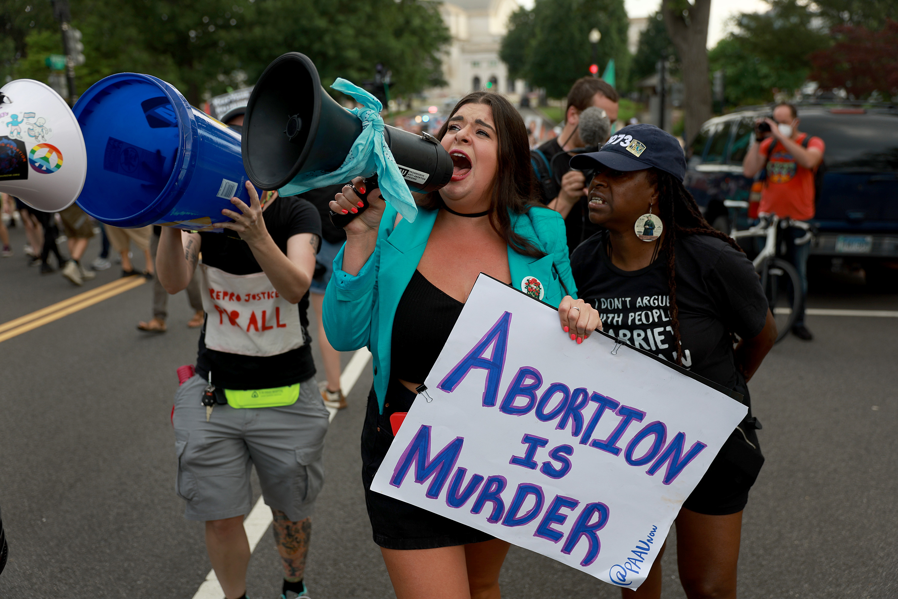 Protesters, some of whom are in support of abortion rights and others that oppose them, walk to the U.S. Supreme Court on June 13, 2022