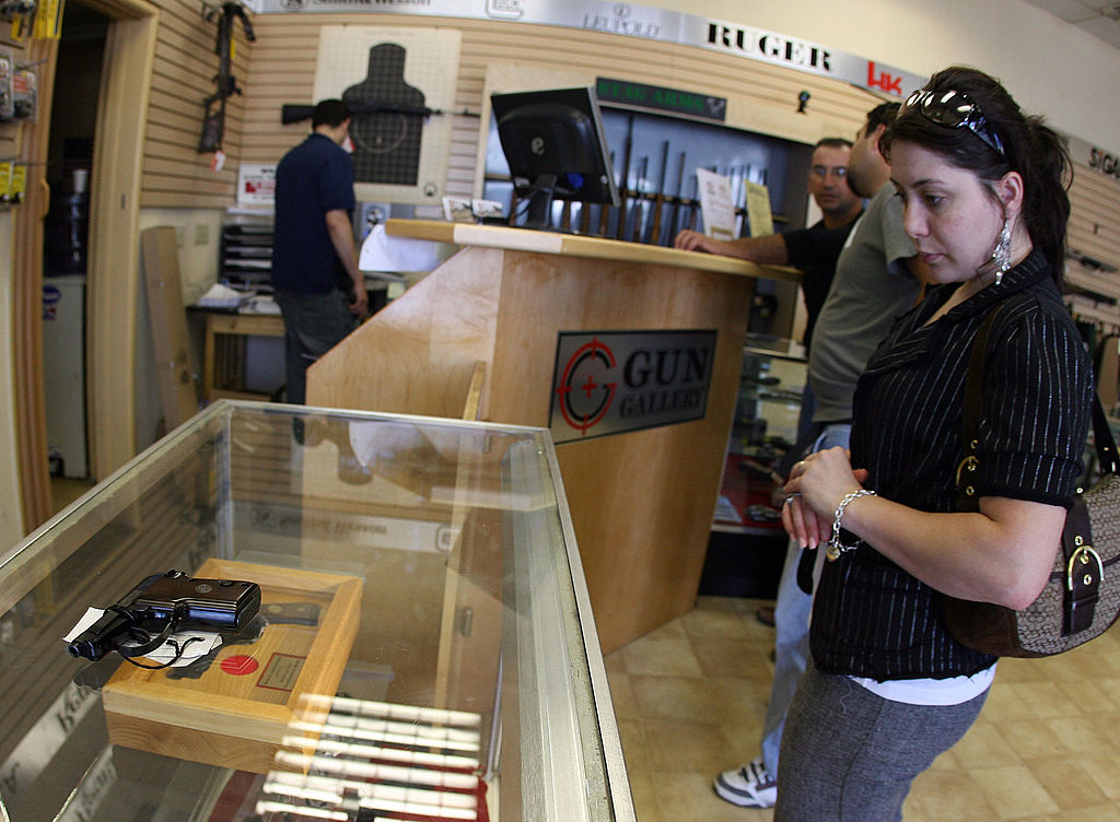 Aida Khachikyan chooses a gun at the Gun Gallery in Glendale, Calif., April 18, 2007.