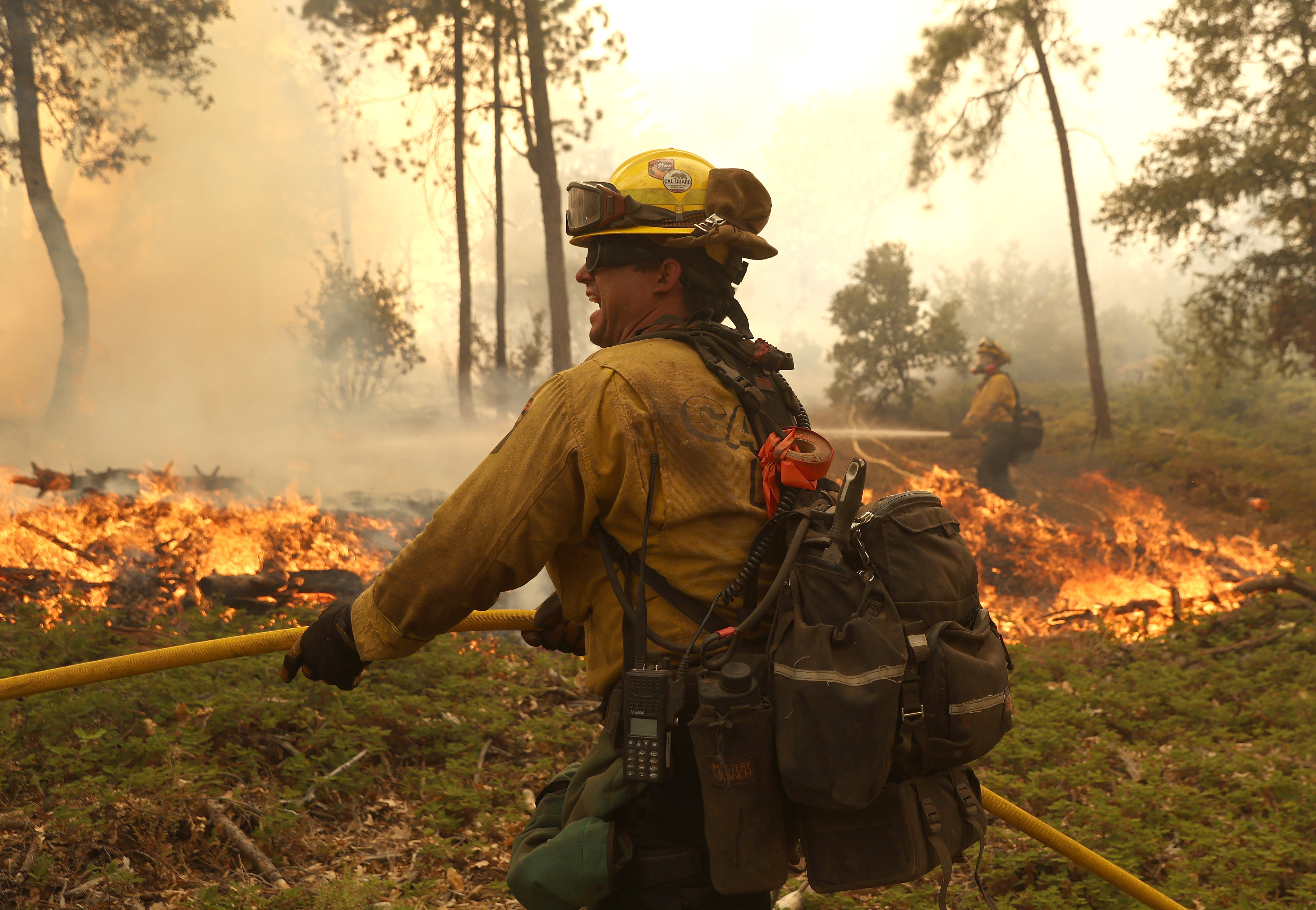 Cal Fire firefighters monitor a burn operation to battle the Oak Fire on Sunday, July 24, 2022 near Jerseydale, Calif. 