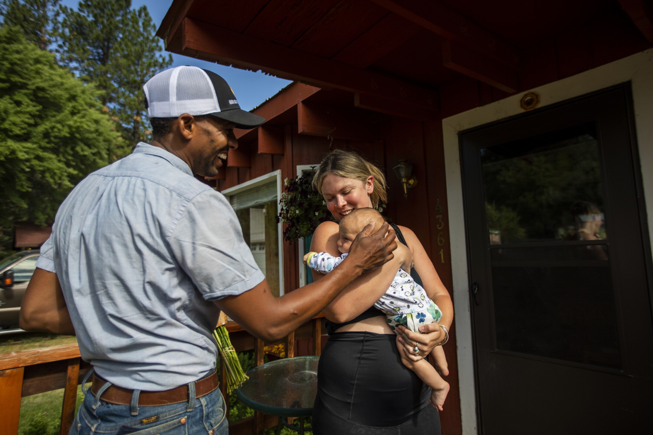 Andre Essue delivers fresh flowers to Lee Crosse and her son, Sky Wilde Crosse, in Taylorsville.