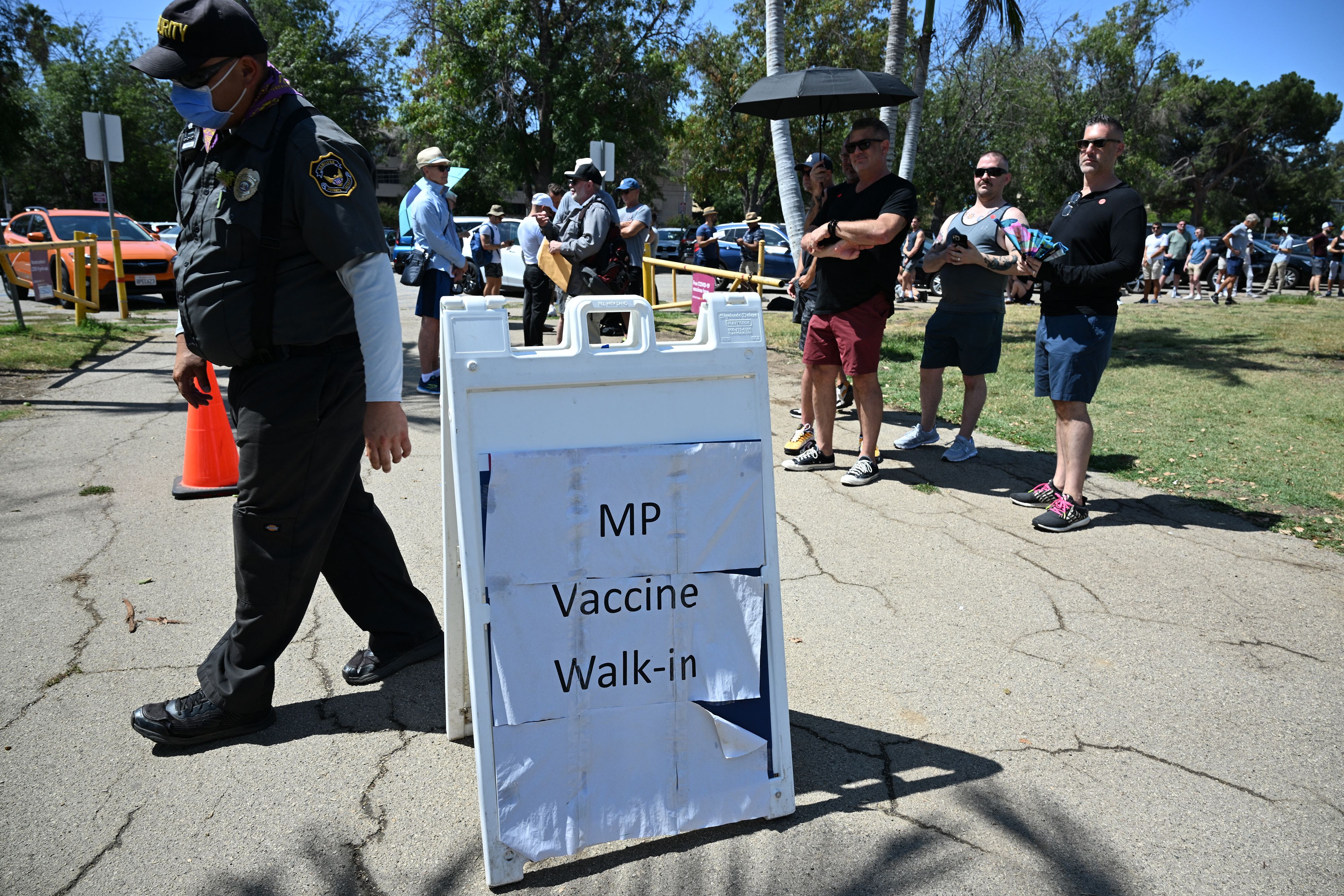 People wait in line to receive the monkeypox vaccine at the Balboa Sports Center in the Encino neighborhood of Los Angeles, Calif., July 27, 2022.