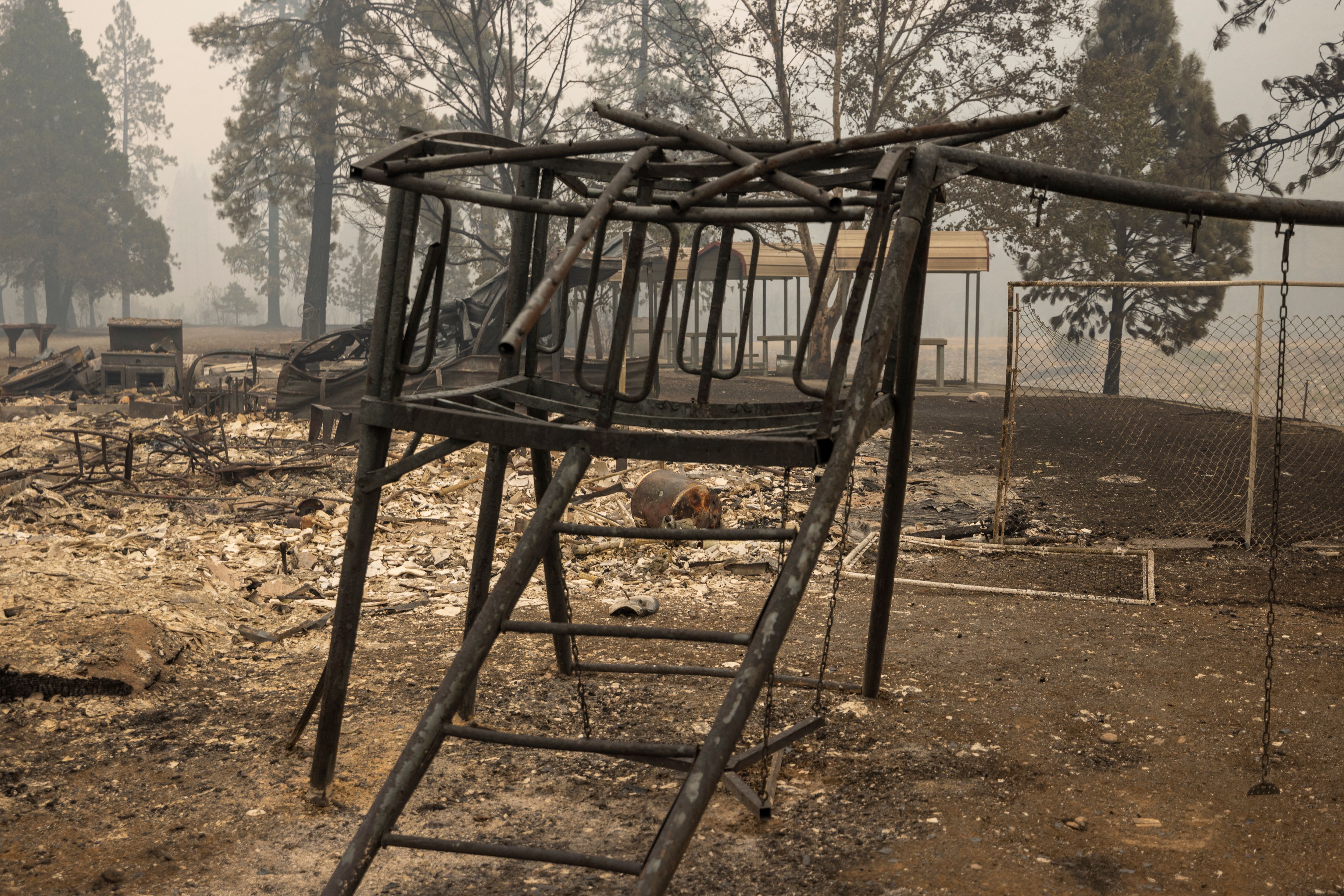 Burned playground equipment is seen in the ruins of the century old Klamath River Community Hall.
