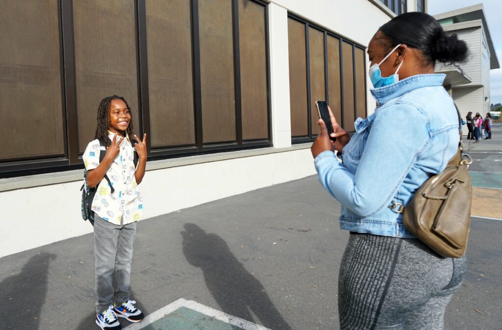 Jameela Jackson snaps a photo of her son Shadeede, a third-grader, at Markham Elementary in Oakland Unified