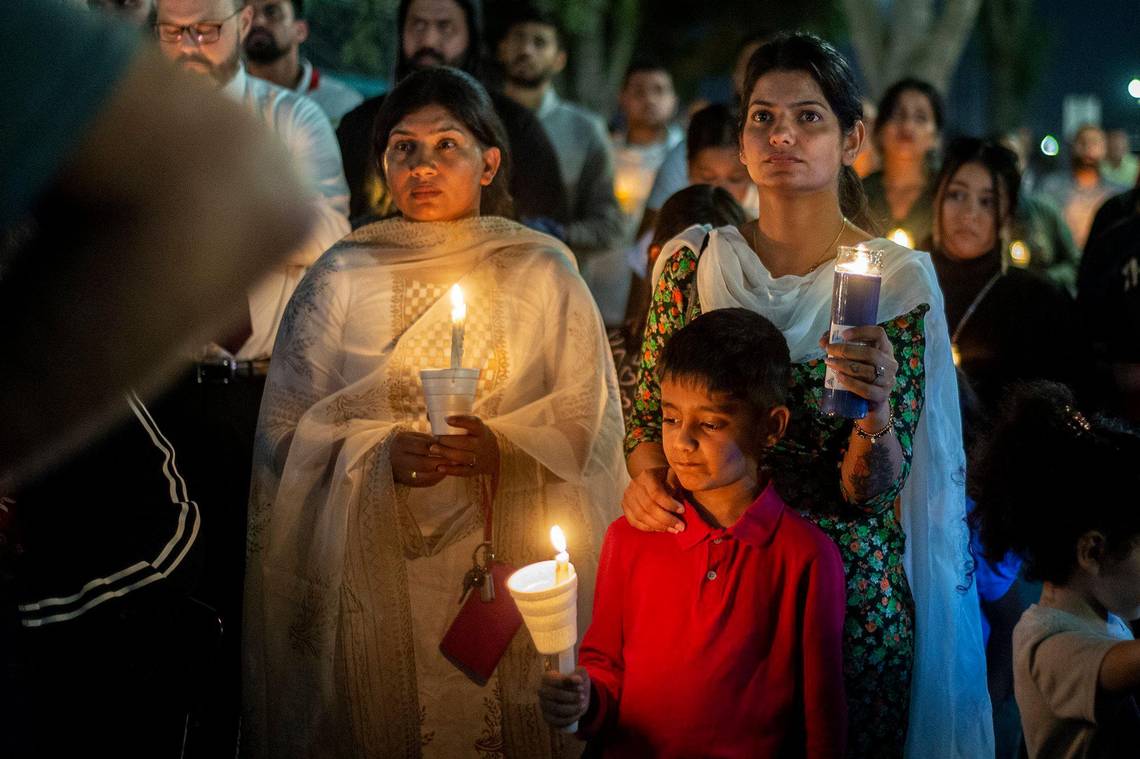 Sukhjeet Kaur, 28, of Fresno, places her hand on the shoulder of son Nirmol Singh, 7, during a vigil for 8-month-old Aroohi Dheri, her parents Jasleen Kaur, 27, and Jasdeep Singh, 36, and her uncle Amandeep Singh, 39, at Bob Hart Square in Merced, Calif., on Thursday, Oct. 6, 2022.