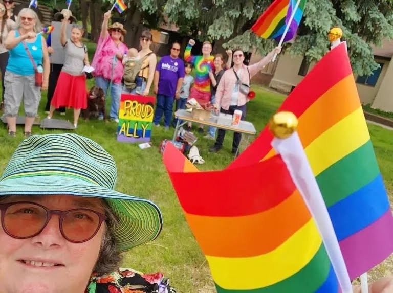 Susan Thornton Zahn takes a selfie along with others attending a Pride potluck in rural Susanville, Calif., in June 2022.