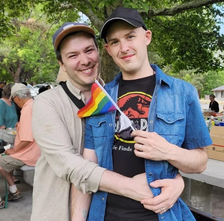 Jacob Hibbitts and his husband, Richard Colvin, at the Pride potluck in rural Susanville, Calif., in June 2022.