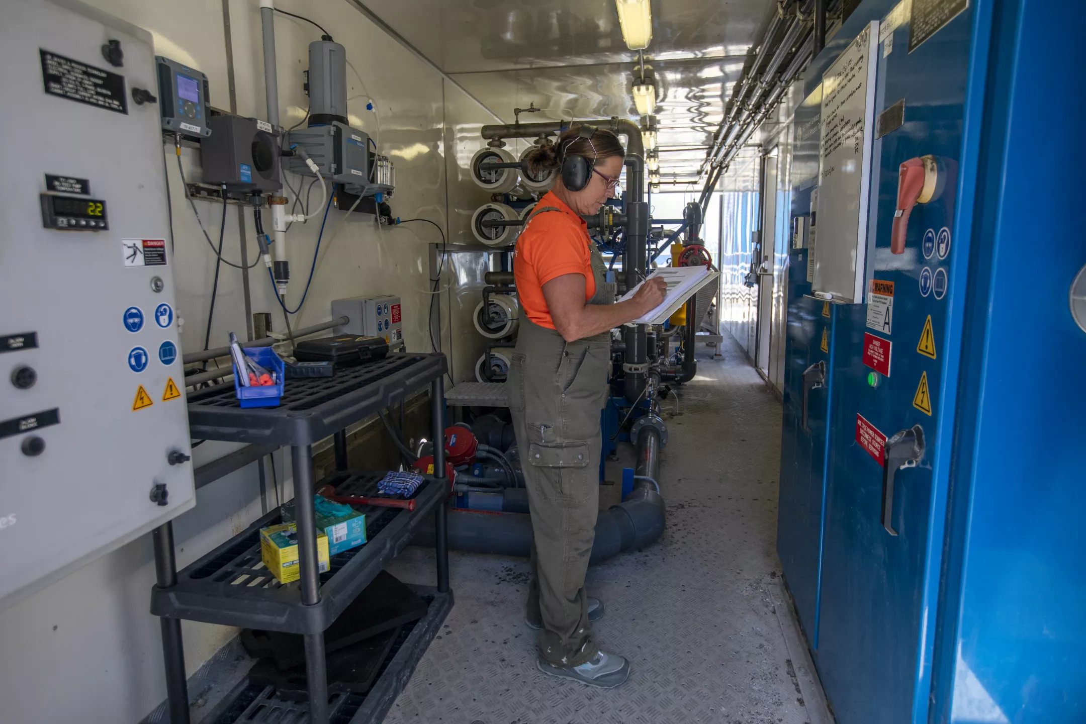 Jessie McDonald, a water and gas operator mechanic at Southern California Edison, checks the numbers inside the desalination plant in Avalon. The facility today provides about 40% of the town's drinking water, and officials have credited it with keeping them out of severe drought restrictions so far this year.