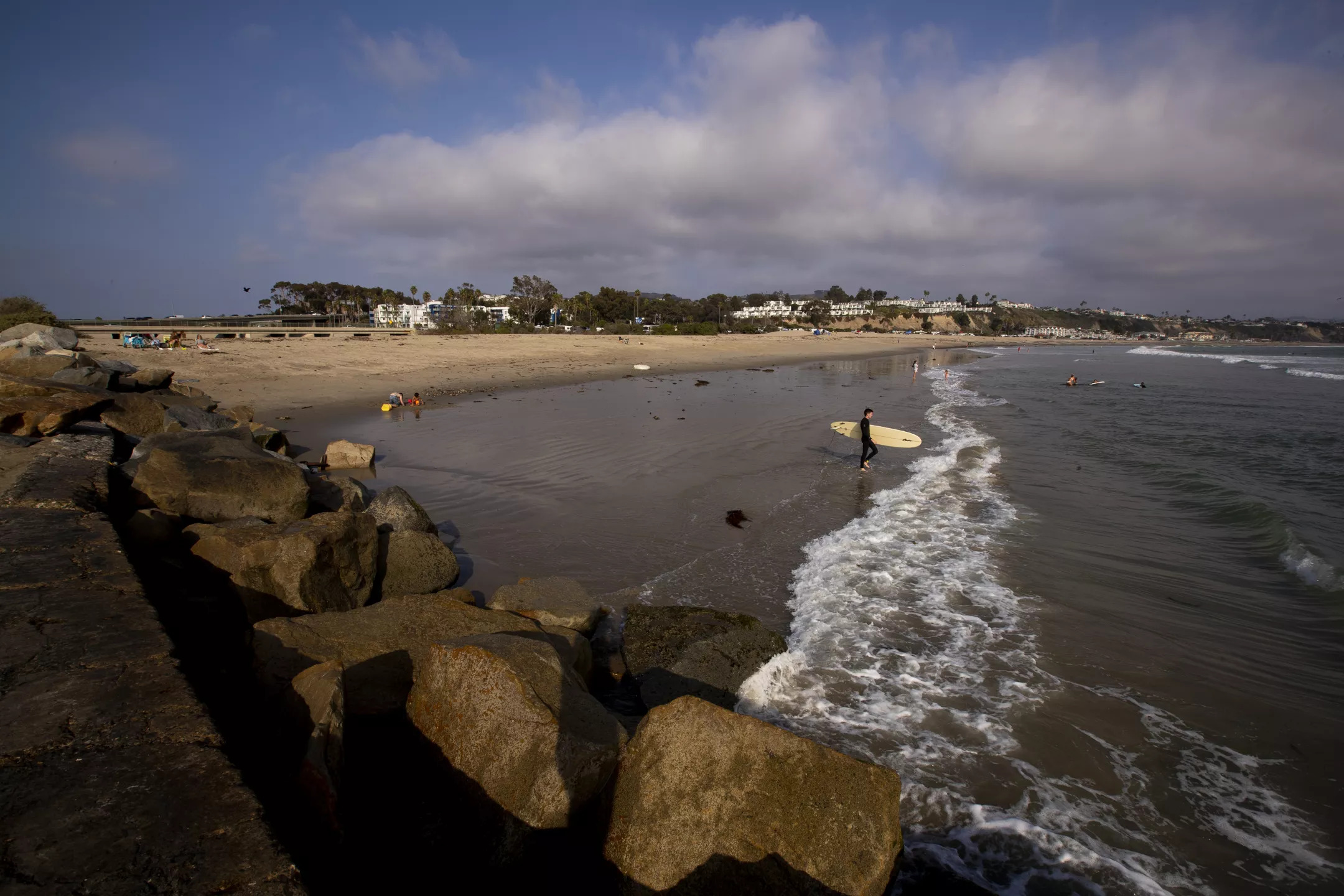 A surfer heads out near where the South Coast Water District has proposed building a desalination plant about 1,500 feet from the shoreline in Dana Point.