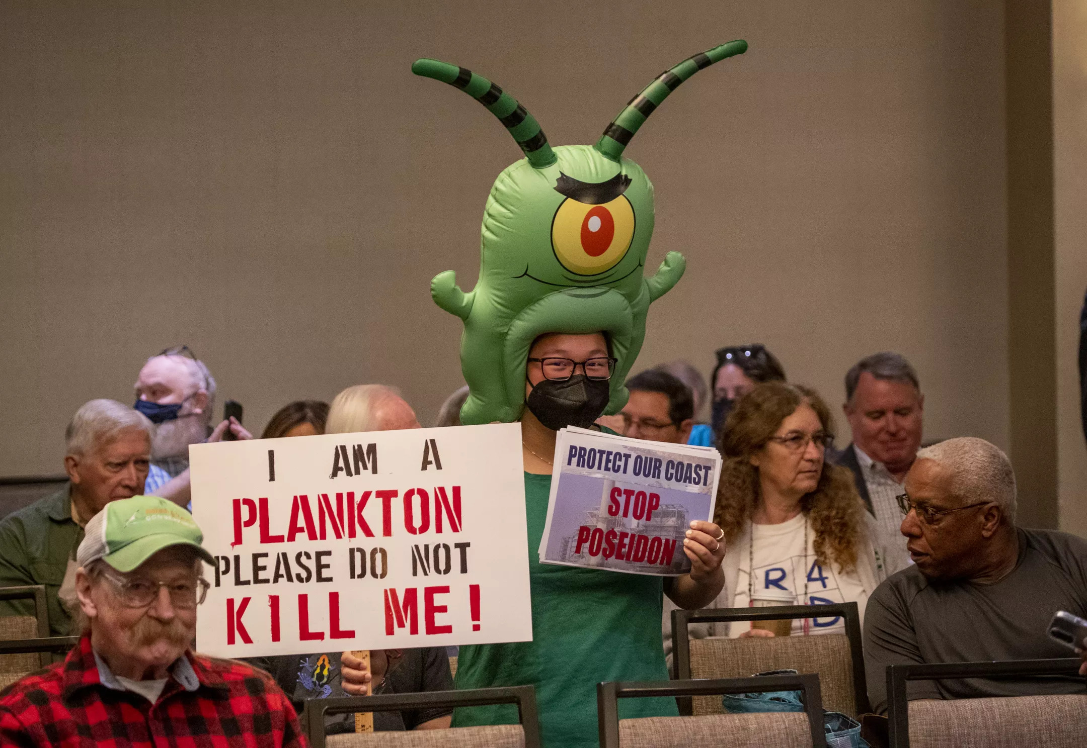 Zoey Lambe-Hommel, who is against Poseidon's proposed desalination project in Huntington Beach, attends the California Coastal Commission hearing in Costa Mesa, where the project was ultimately rejected. 