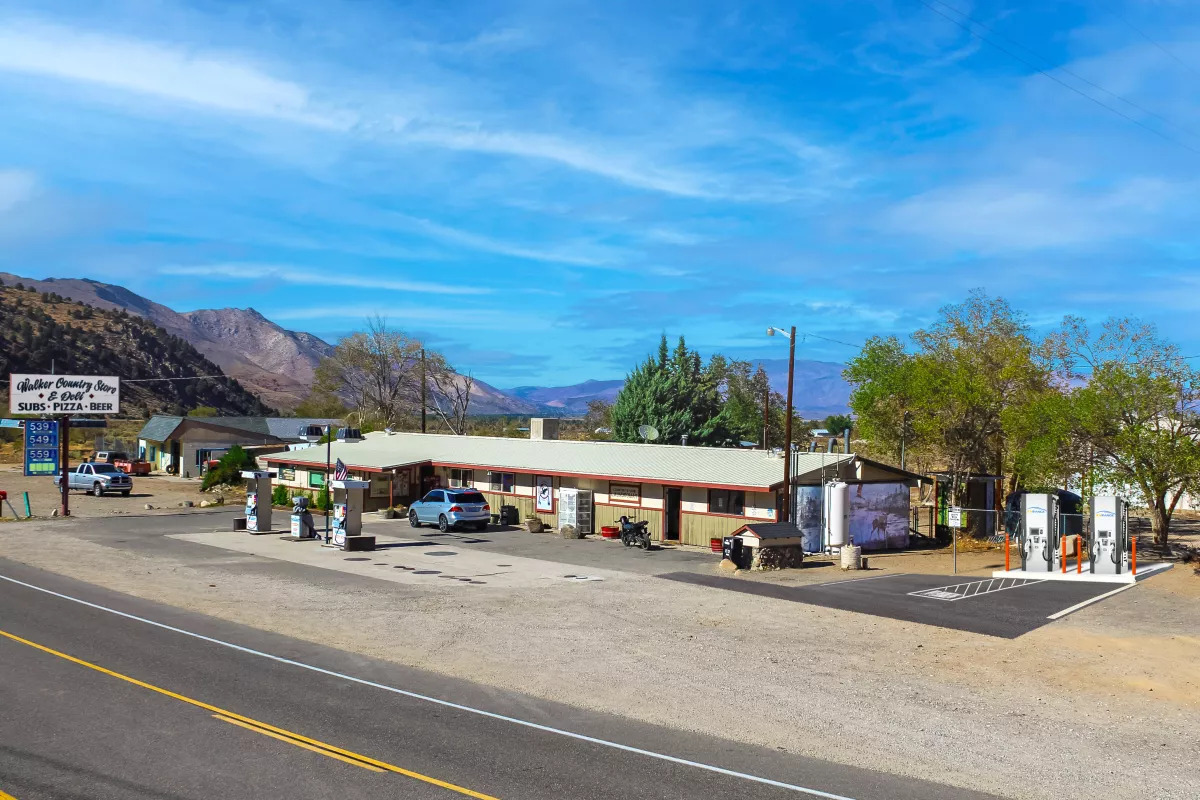 A rendering of an electric vehicle charging station, right, slated to be developed by EV Range at the family-operated Walker Country Store gas station in Walker, Calif.