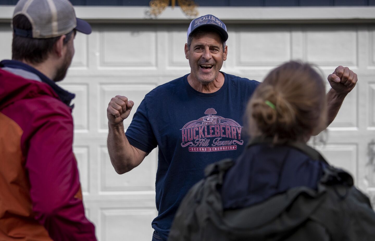 Johnny Casali, center, celebrates a small victory as he's told a minor infraction found during a state inspection of his cannabis farm won't involve a fine or sanction.