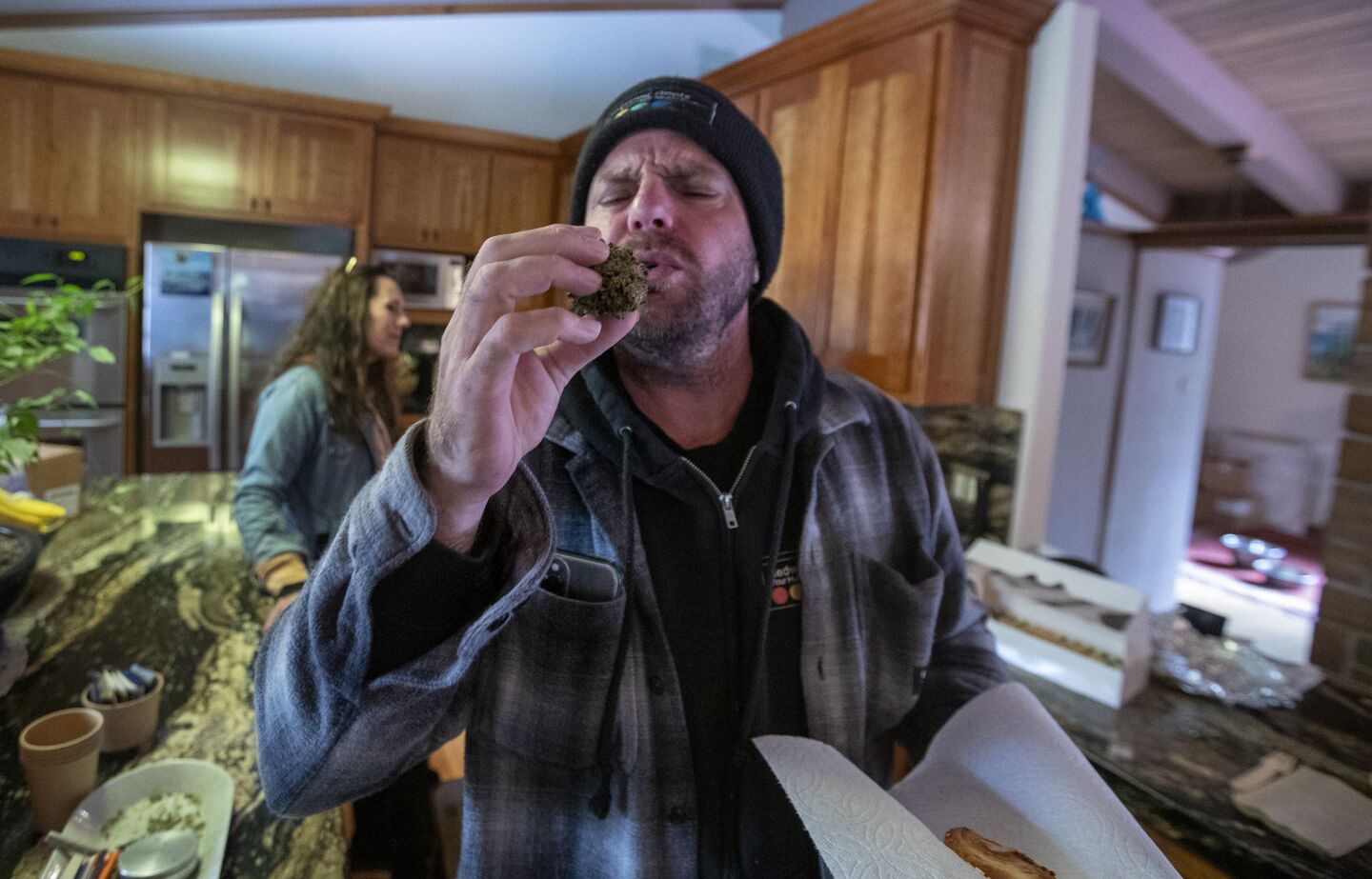 Chris Anderson, left, chief executive of cannabis distributor Redwood Roots, inspects cannabis from Lady Sativa Farm during a meeting last month with growers and distributors at Huckleberry Hill Farms.