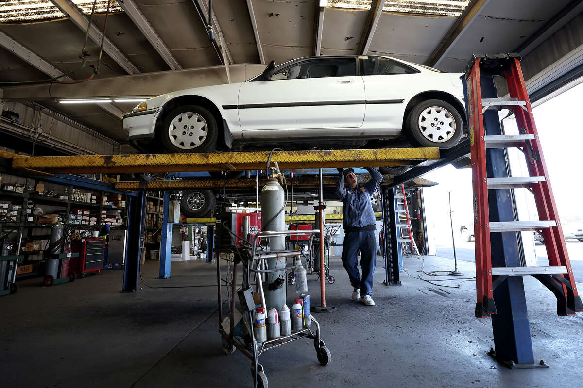 Luis Benitez works on a car at Johnny Franklin's Muffler on July 11, 2022, in San Rafael, Calif.