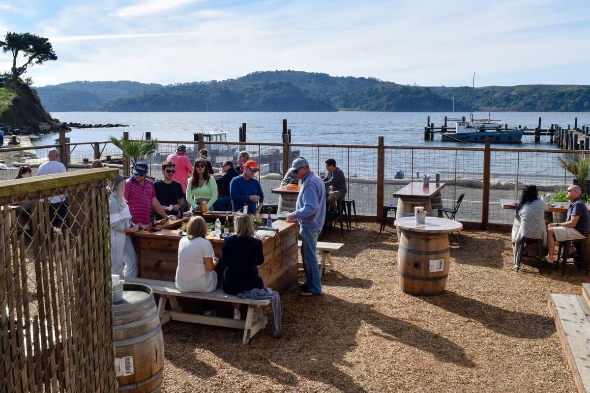 Customers enjoy the outdoor seating at the Marshall Store on Tomales Bay in Marshall, Calif.