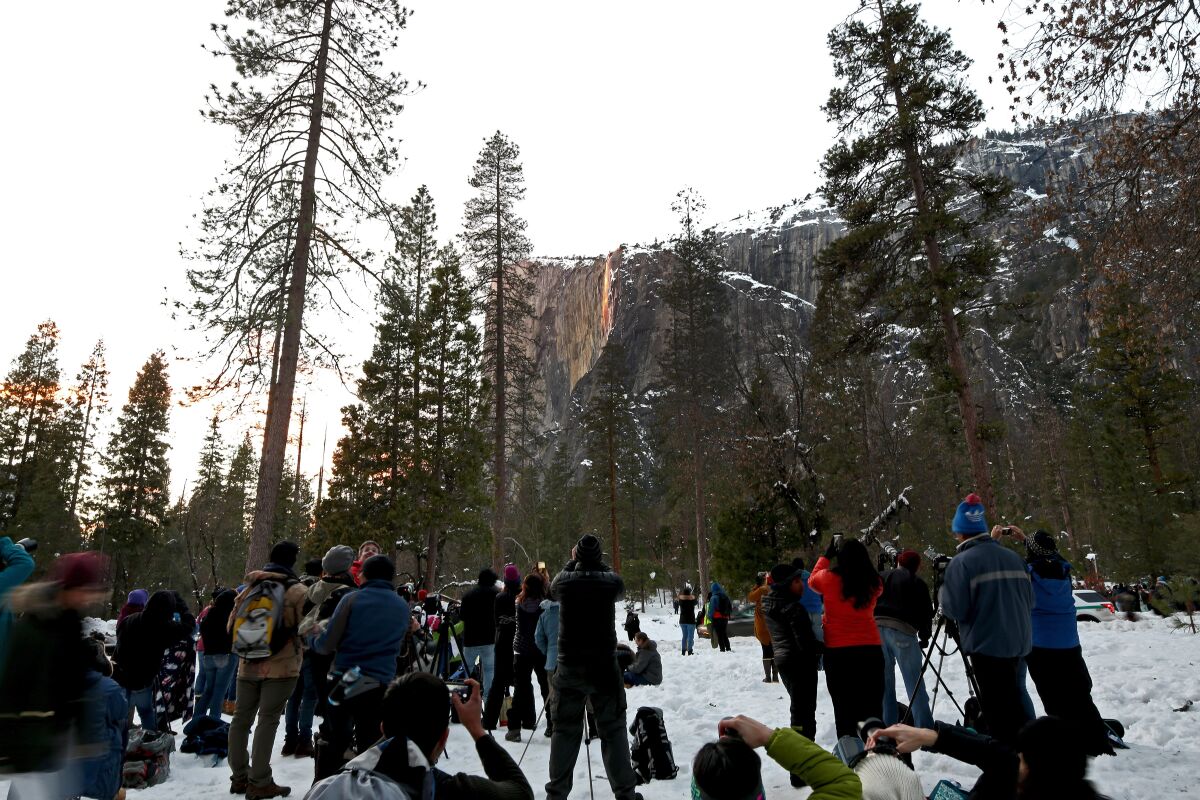 People gather in Yosemite hoping to catch a glimpse of the Horsetail Fall firefall effect caused by light from the setting sun.
