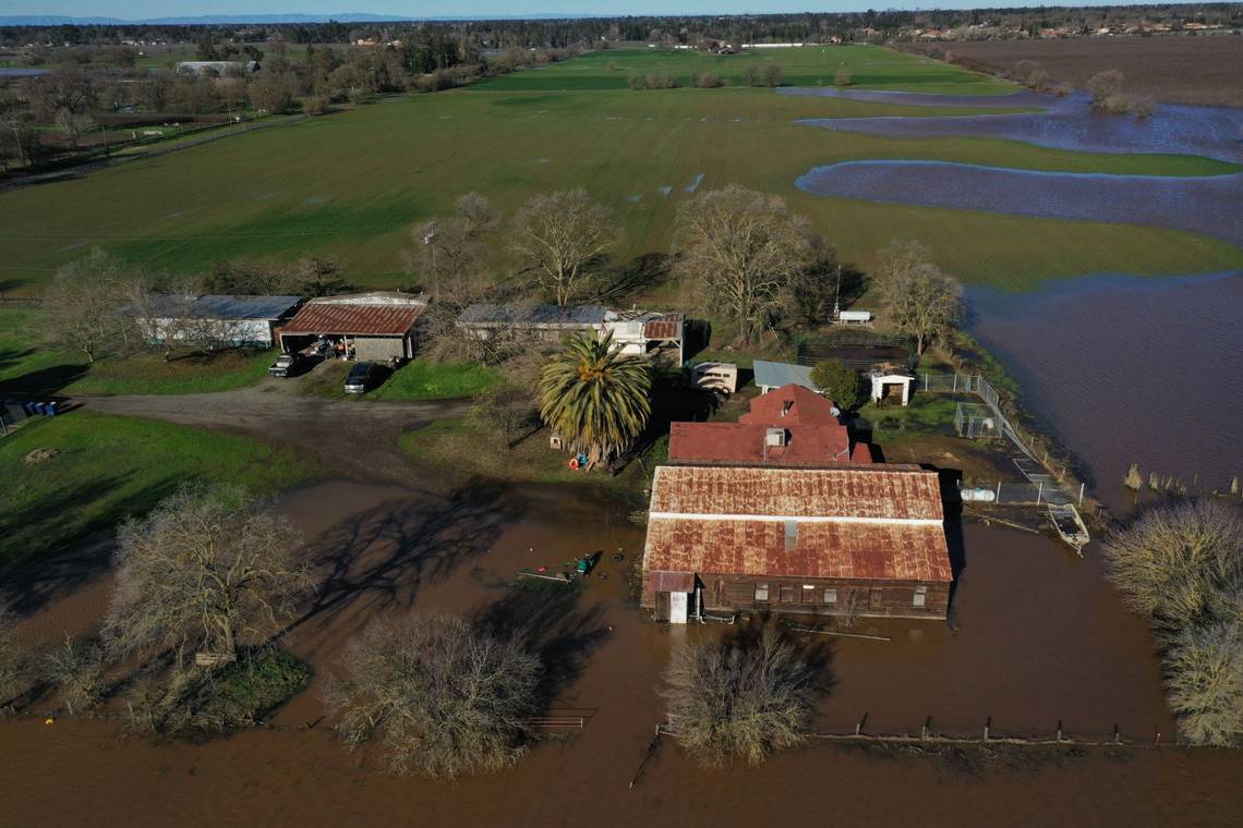 A farm on Freeman Road south of Elk Grove is surrounded by flood waters on Sunday, Jan. 1, 2023, following flooding from heavy rains on New Year's Eve.