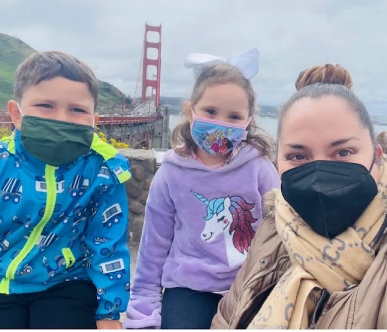 Lily Marquez, right, takes a photograph with her two children.
