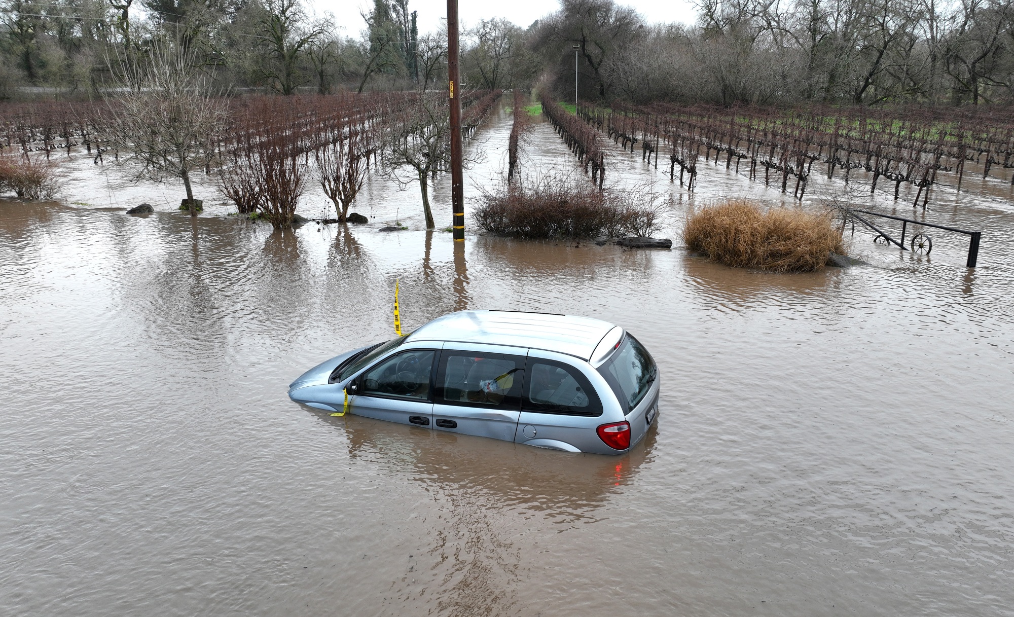 A car is submerged in floodwater after heavy rain moved through the area on Jan. 9, 2023 in Windsor, Calif.