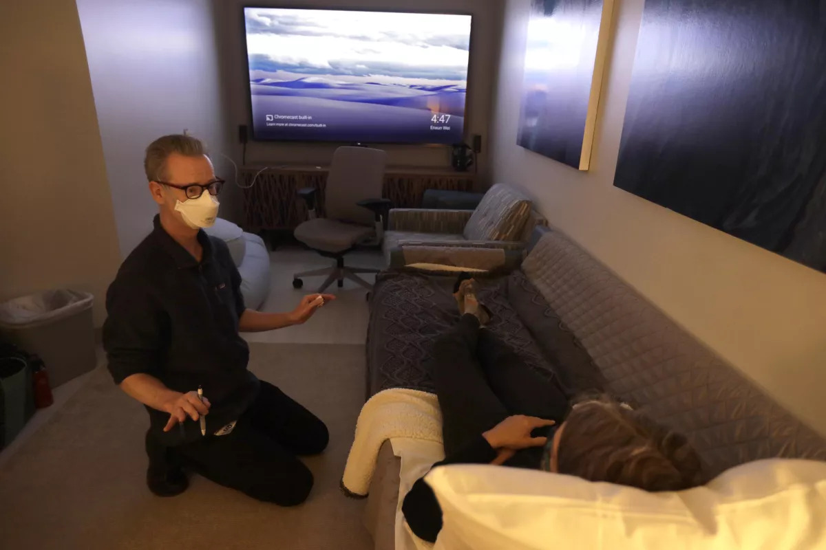 Dr. Keith Heinzerling speaks with Melanie Senn before a psilocybin session at the Pacific Neuroscience Institute.