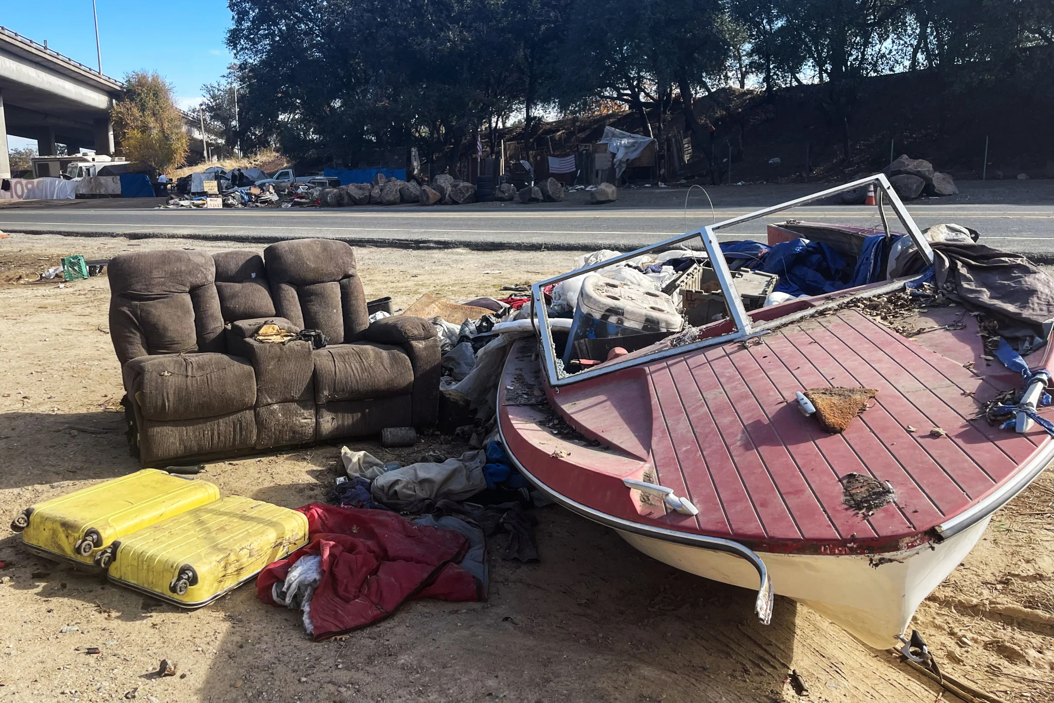 Homeless encampments crowd the freeway underpasses and dirt shoulders along Roseville Road, northeast of downtown Sacramento, along with piles of trash and discarded goods.