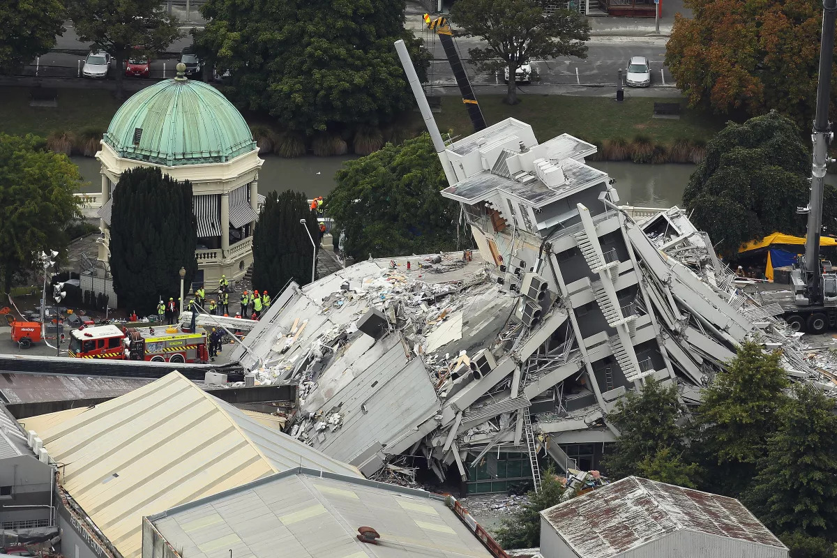 Rescue workers surround the Pyne Gould Corp. building in Christchurch, New Zealand, on Feb. 23, 2011, after a magnitude 6.3 earthquake.