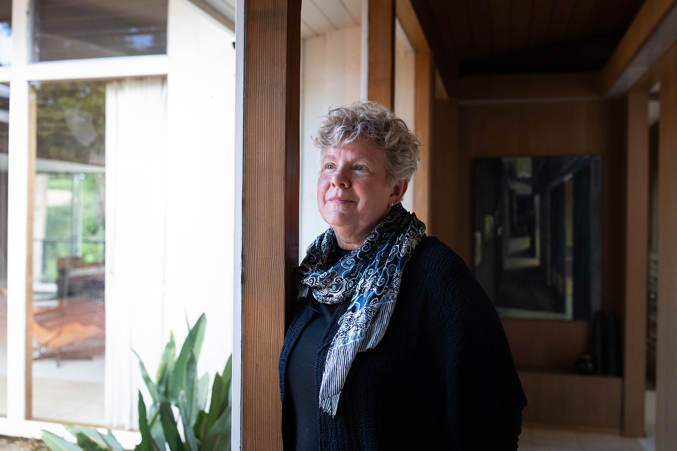 Santa Cruz County Health Officer Dr. Gail Newel stands near a window, smiling.