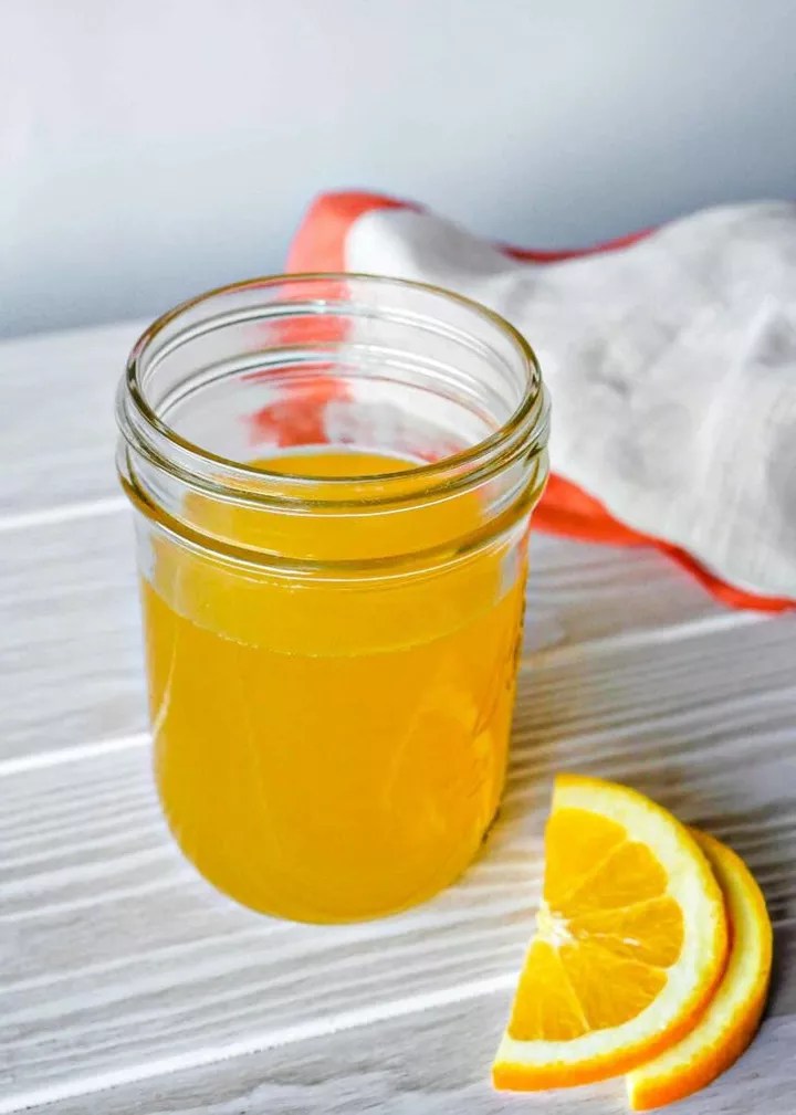 A mason jar of Winter Spiced Orange Mocktail