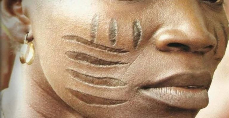 woman's face with lines of the Owu tribal marks