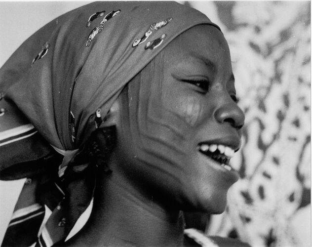 smiling lady with Keke tribal marks on her face