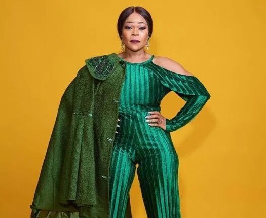 Shaffy Bello posing in a green outfit