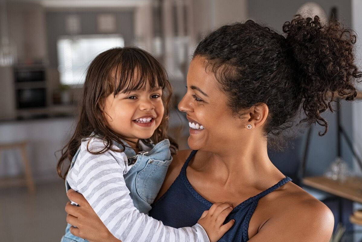 a mom and her daughter playing