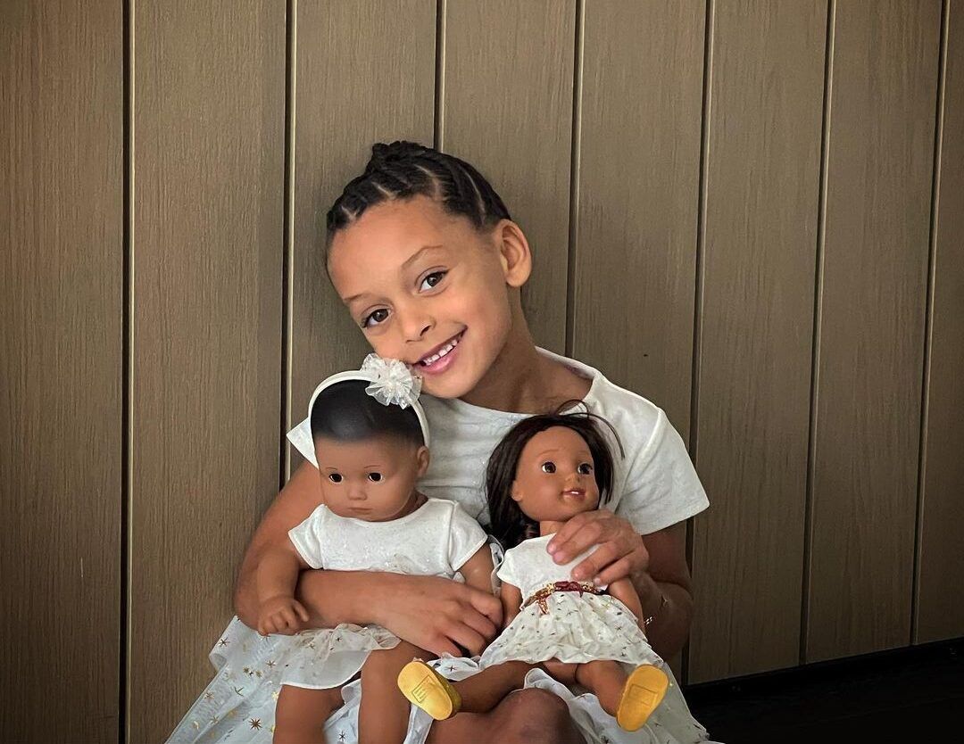 Ryan Carson Curry smiling with her dolls